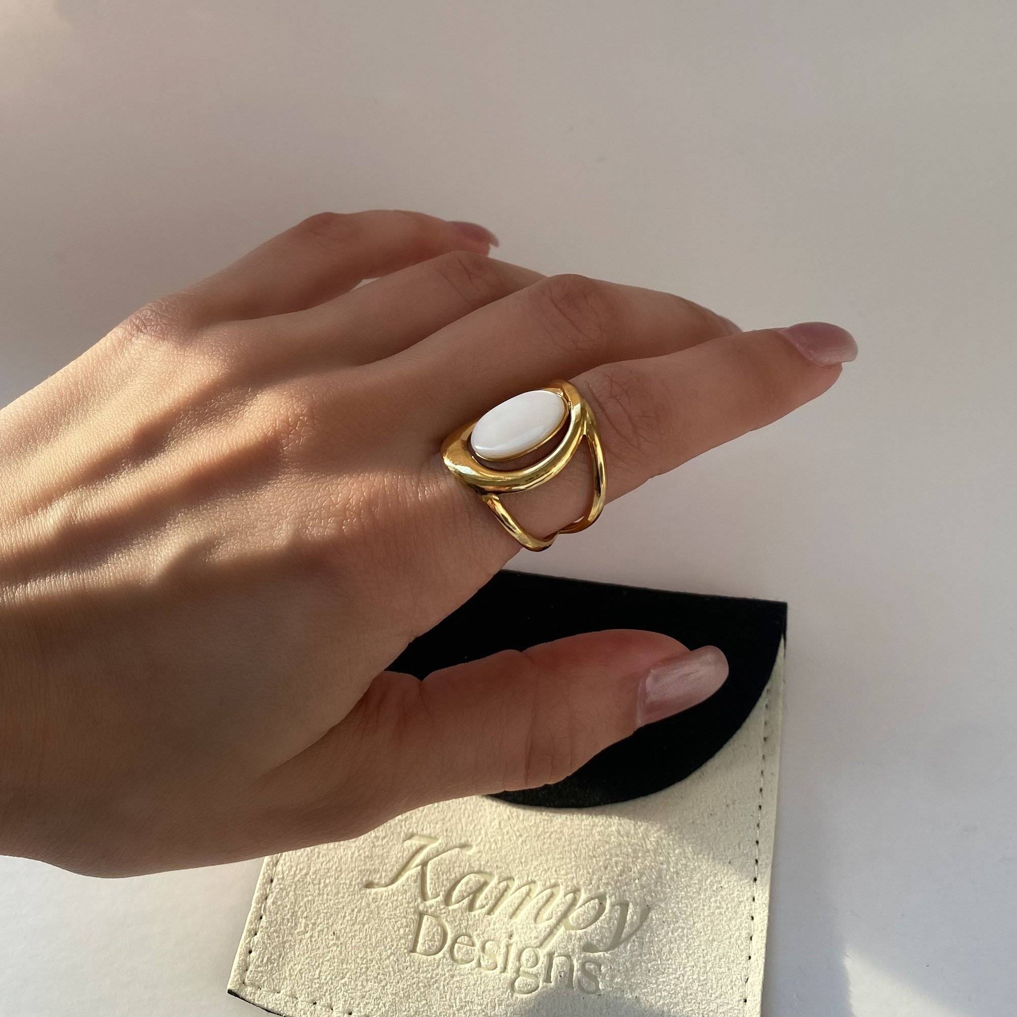 Styled view of Kostar opal split shank ring by Kampy Designs, displayed alone for a clean, editorial presentation.