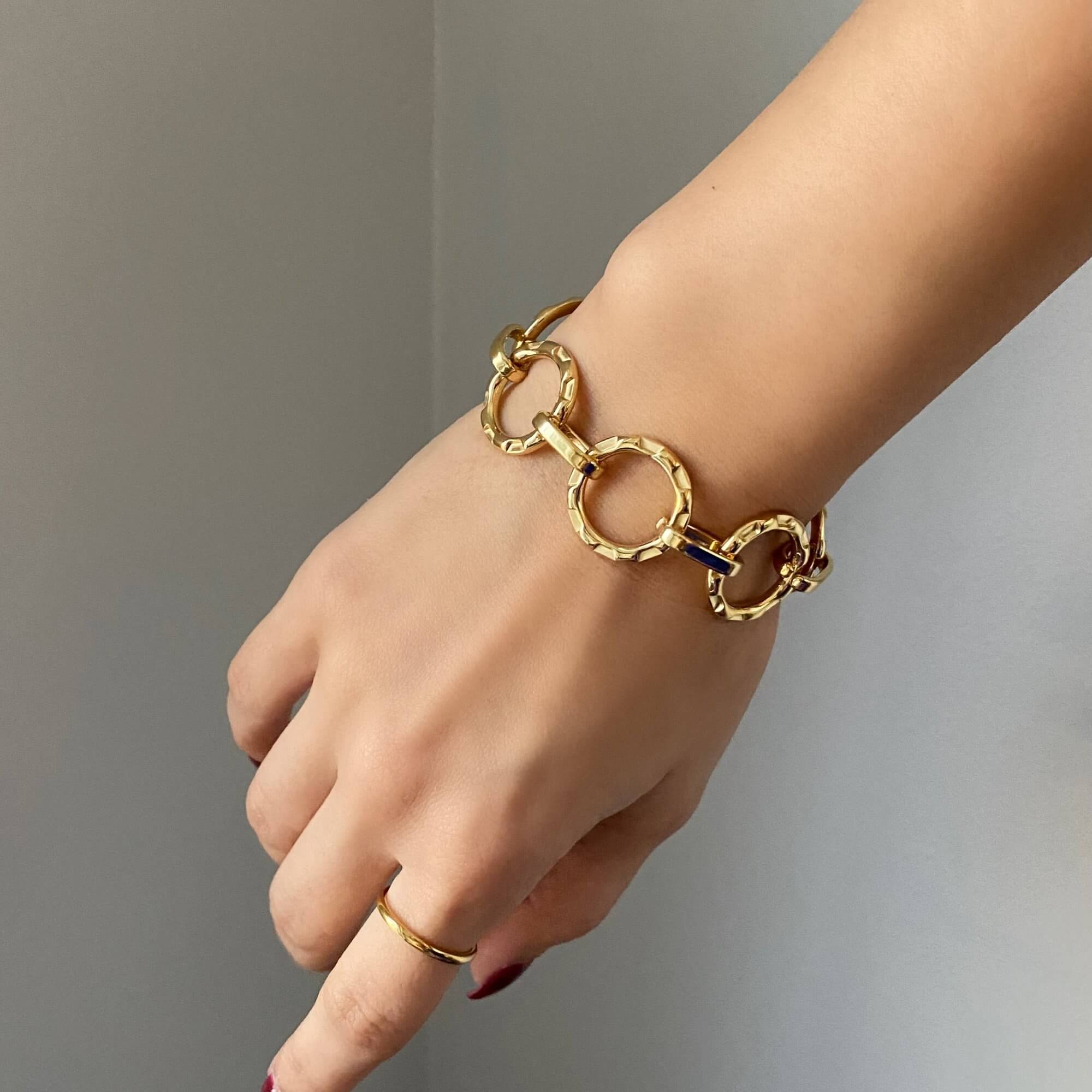 Angled view of the KostyB open circle charm bracelet by Kampy Designs, capturing its fine craftsmanship and polished gold accents.