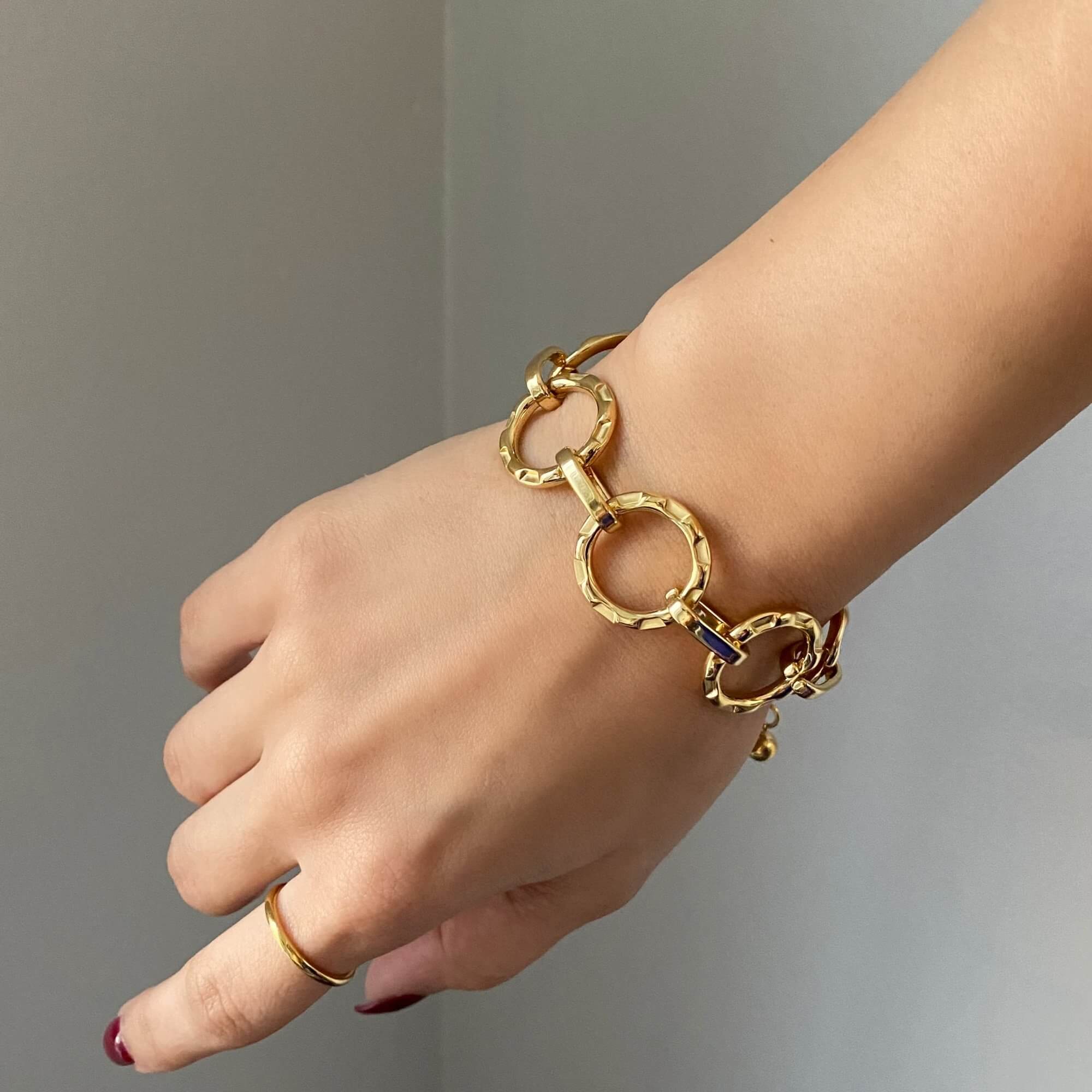 Side view of the KostyB open circle charm bracelet by Kampy Designs, capturing its delicate chain and shimmering gold charm accents.
