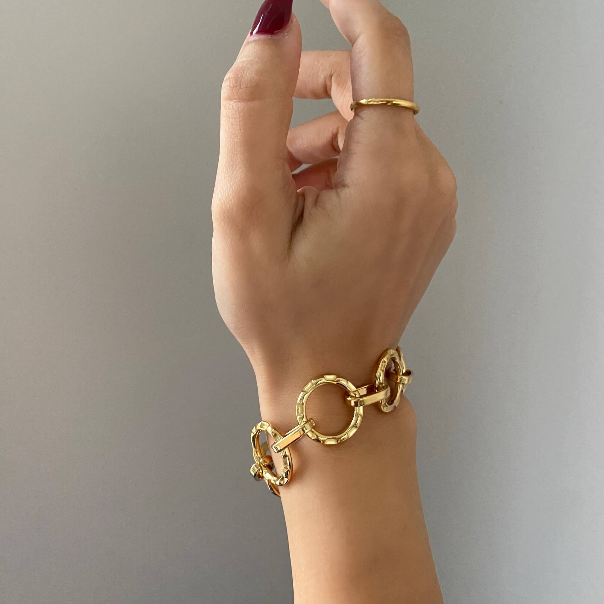 The KostyB open circle charm bracelet by Kampy Designs, elegantly worn to showcase its dainty and sophisticated appeal.