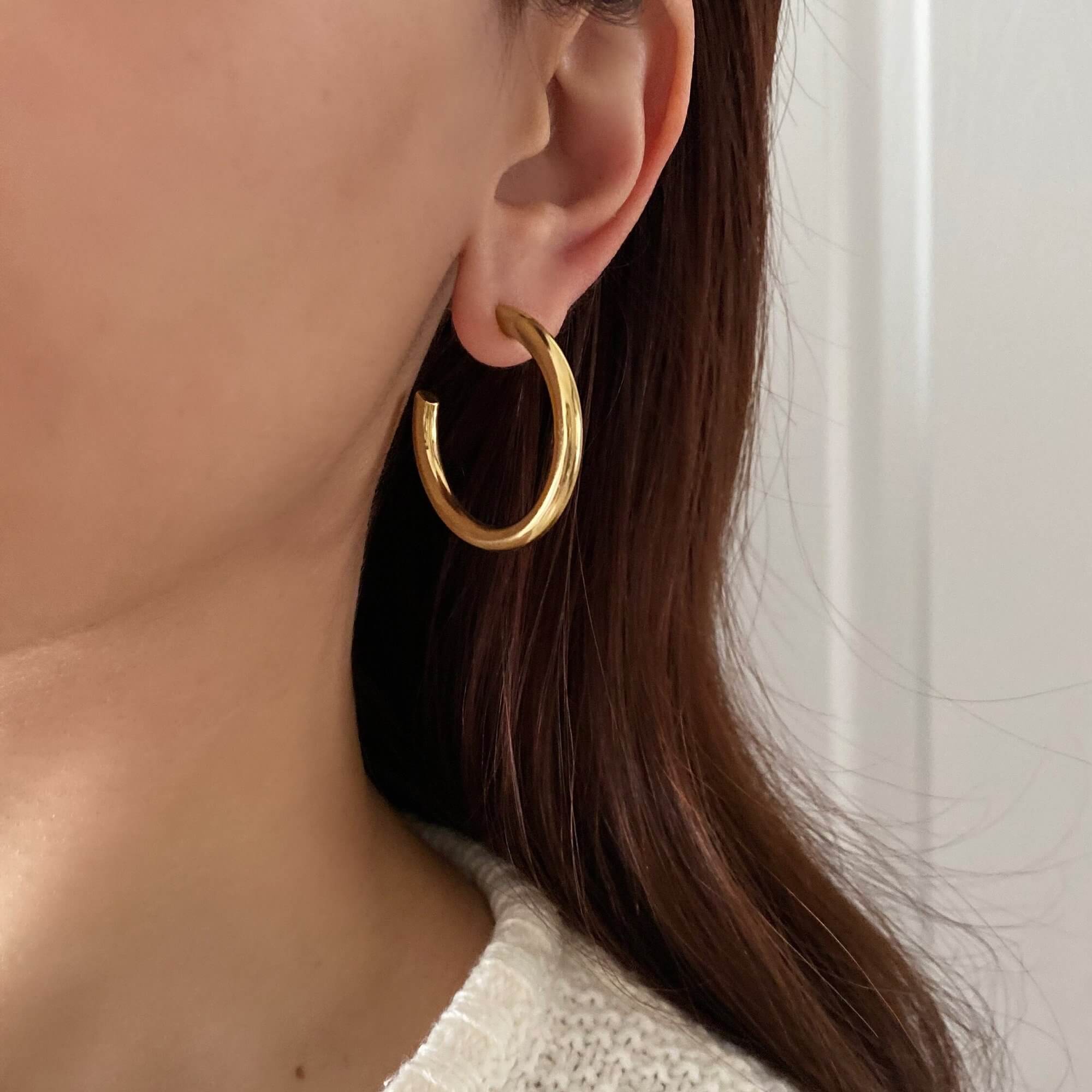 The KarlE medium open circle hoop stud earrings by Kampy Designs, offering a sleek and modern design with a minimalist touch.