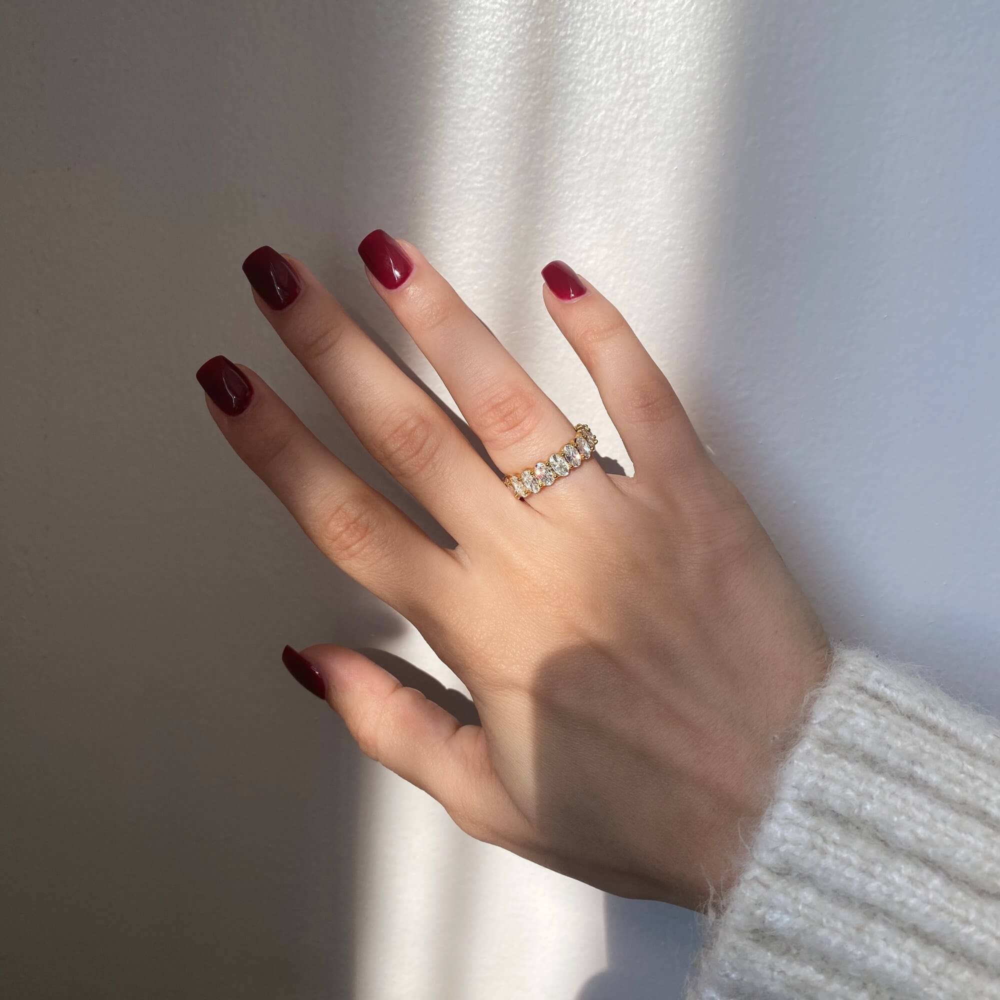 Full view of the KastielR oval diamond eternity ring by Kampy Designs, emphasizing its luxurious diamond arrangement and polished band.