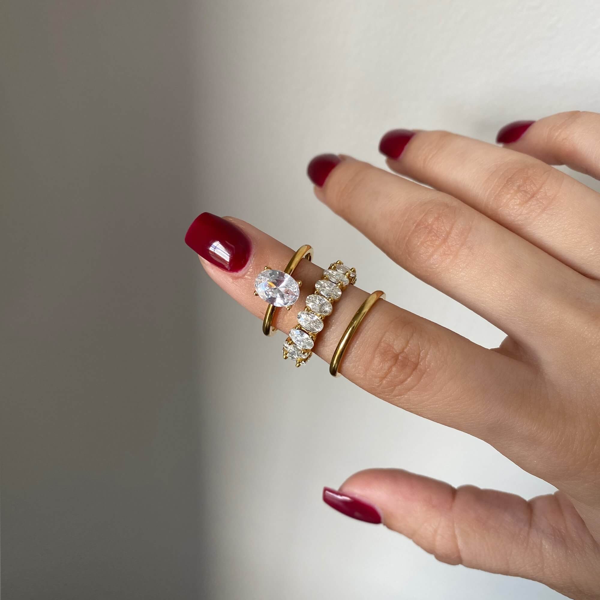 Stacked view of the KastielR oval diamond eternity ring by Kampy Designs, layered with other rings for a bold, elegant style.