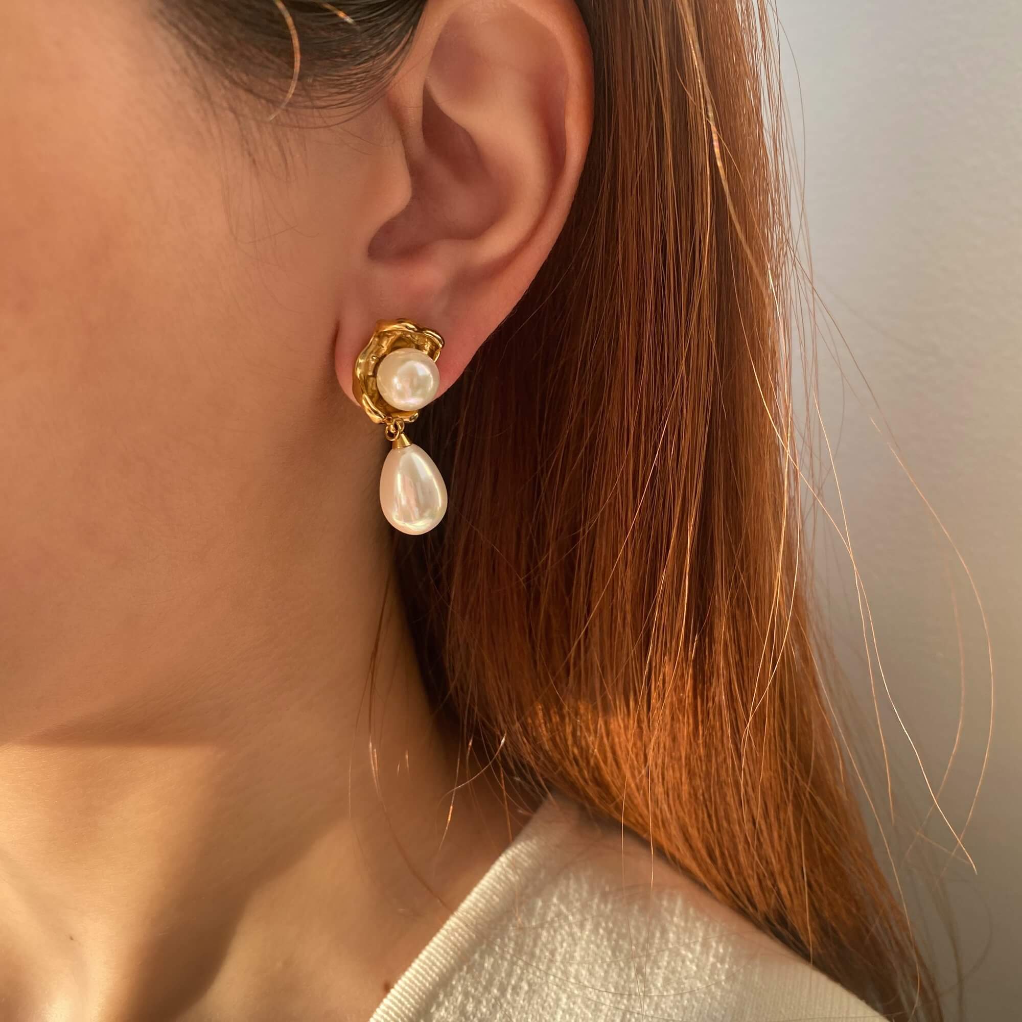 Close-up of KearyE oyster pearl dangle earrings by Kampy Designs, highlighting the natural shell shape and polished pearl drop.