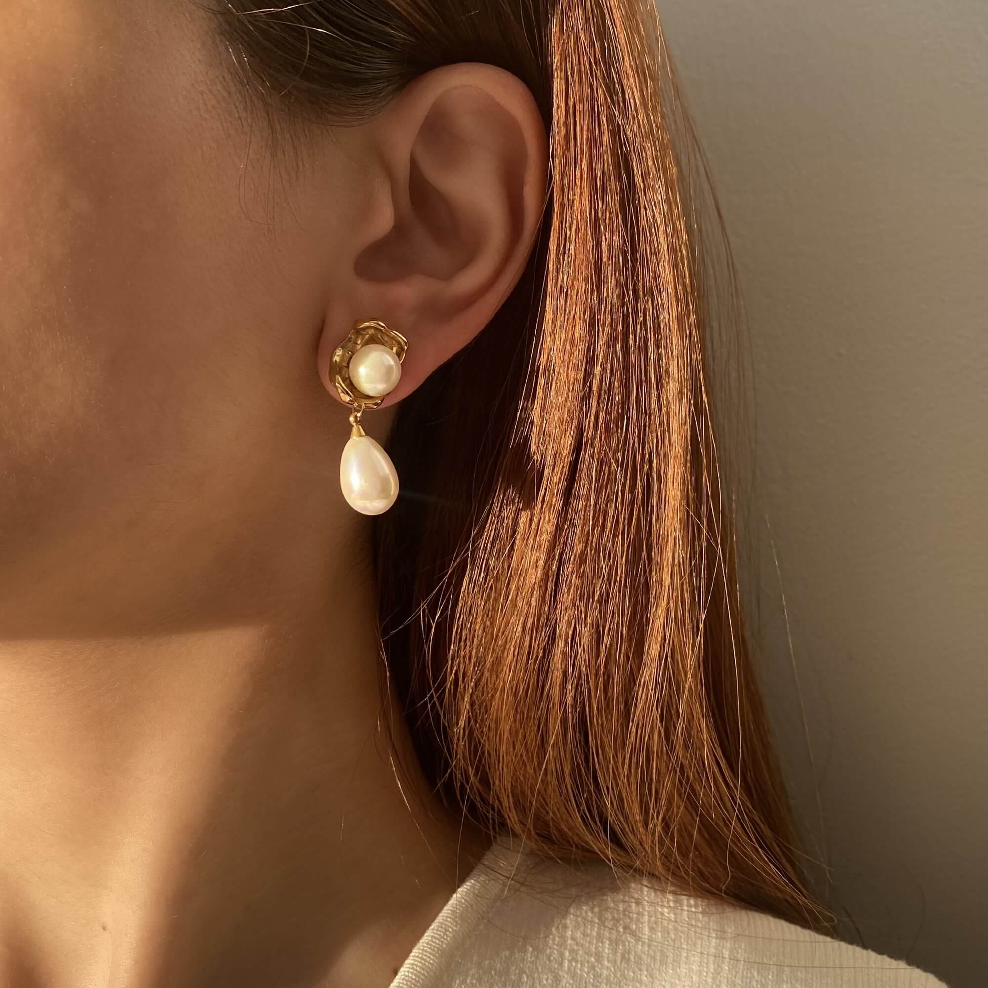 Stacked display of KearyE oyster pearl dangle earrings by Kampy Designs, arranged for a layered, luxurious jewelry presentation.