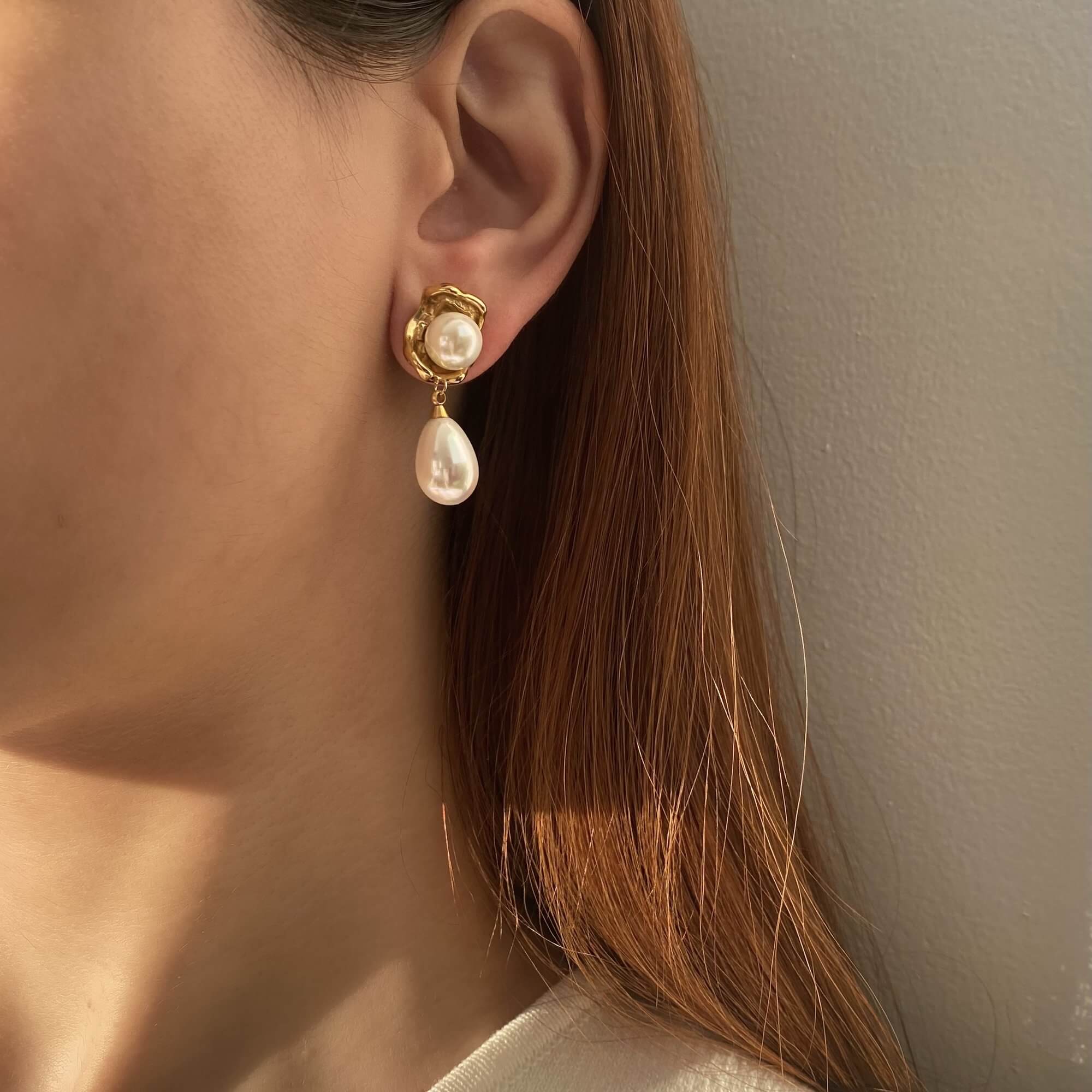 Styled photo of the KearyE oyster pearl dangle earrings by Kampy Designs, arranged with coastal elements for a beach-chic look.