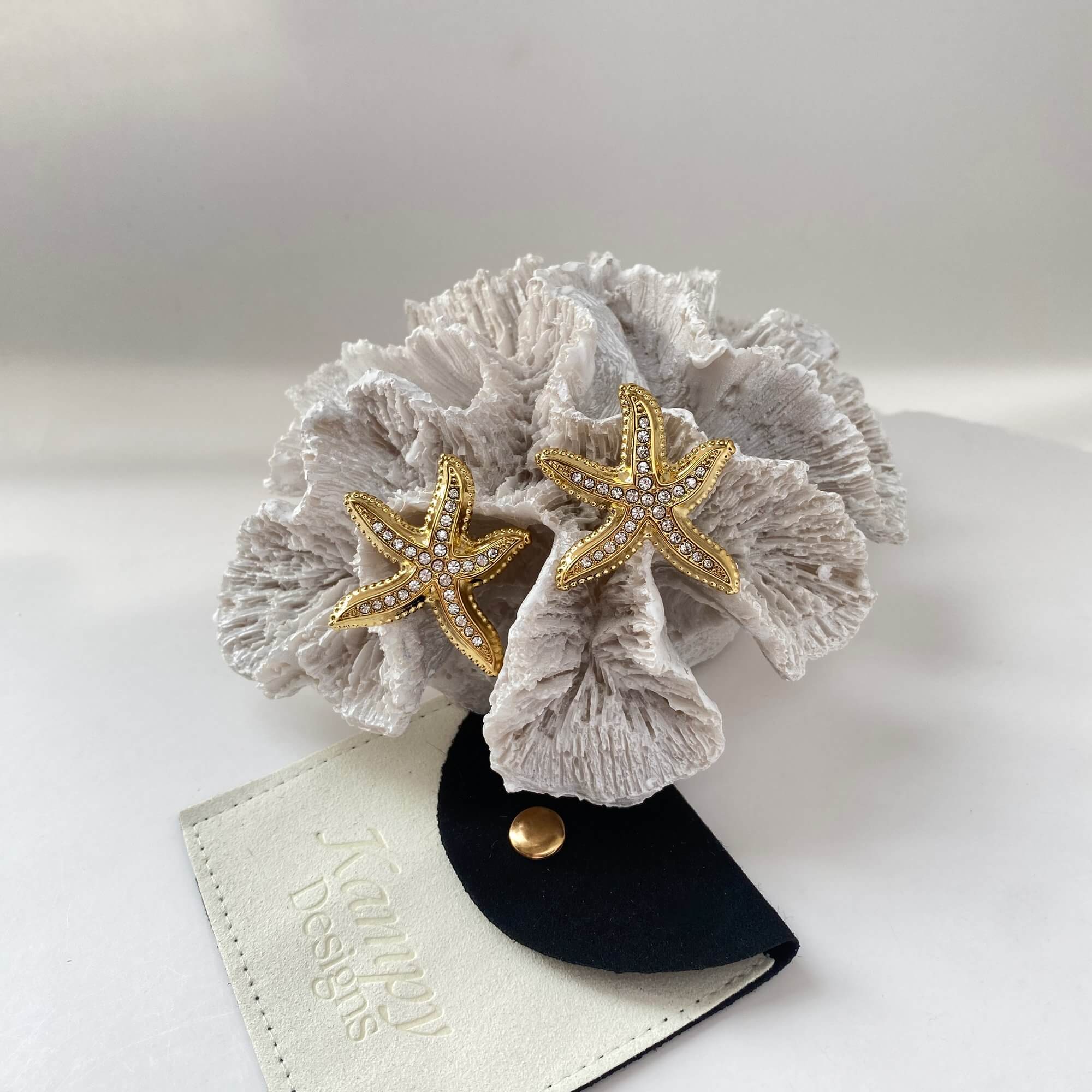 Aesthetic display of the KariyaE pavé starfish earrings by Kampy Designs, styled in a coastal-themed scene for visual impact.