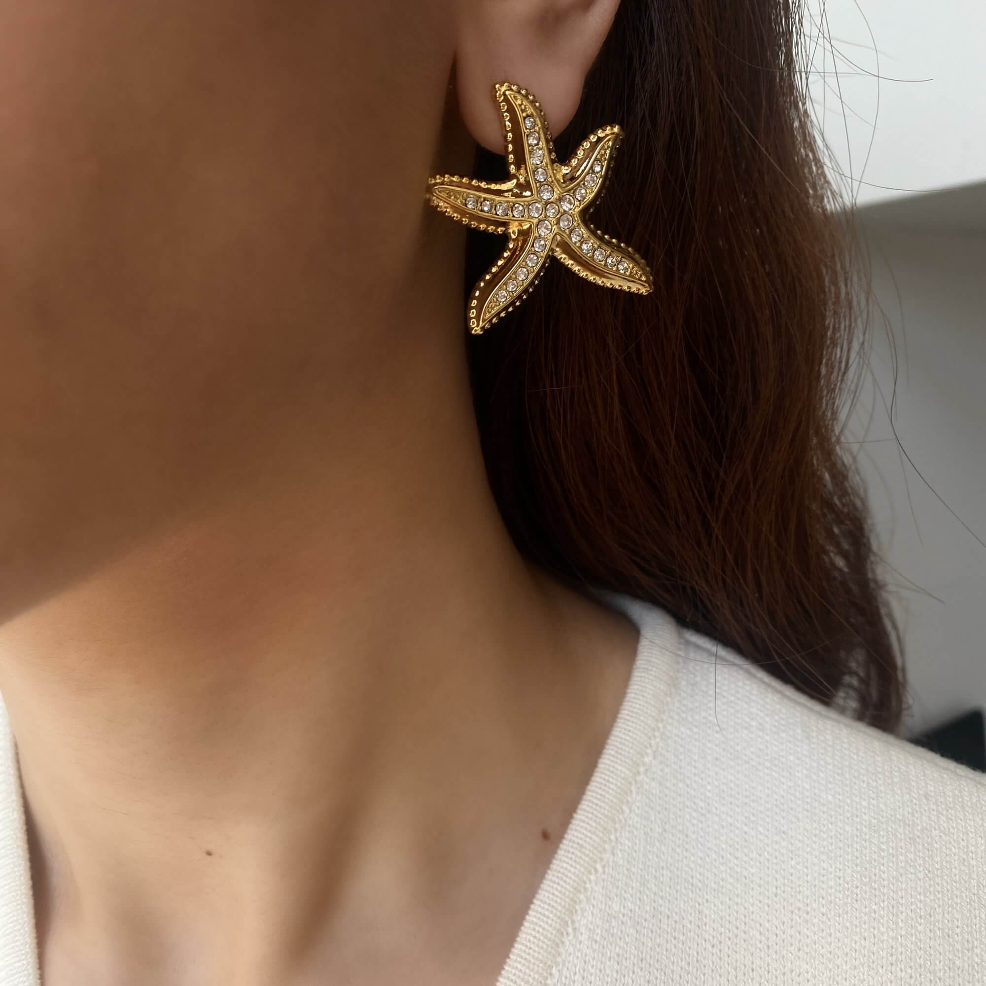 Styled editorial shot of KariyaE pavé starfish statement earrings by Kampy Designs, featuring a bold coastal look.