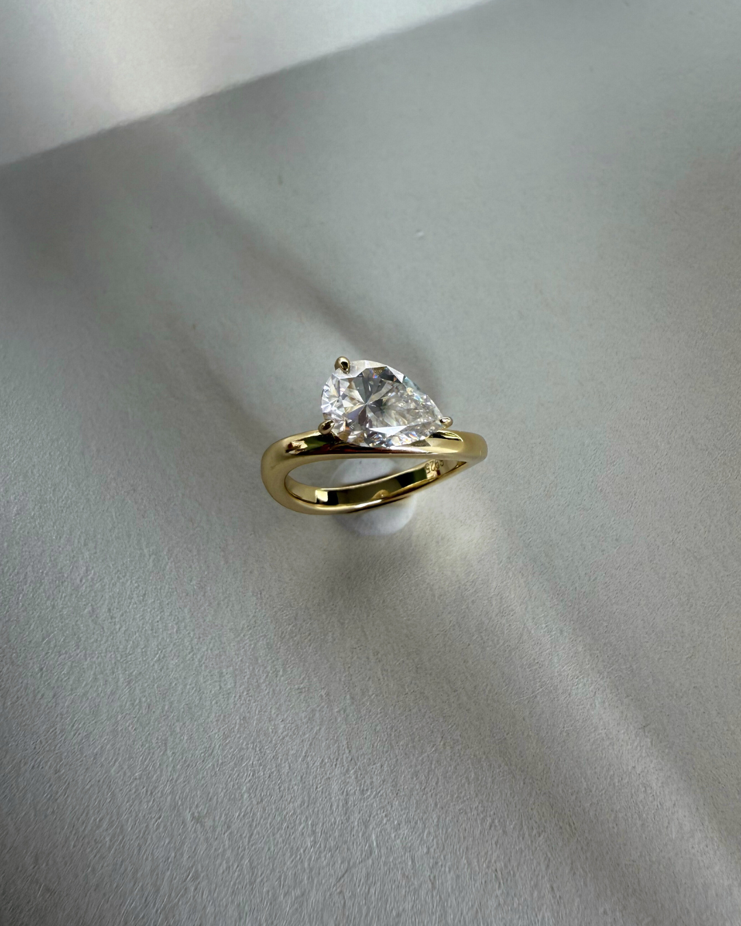 Top view close-up of east-west pear cut moissanite wave ring showing pear stone detail, Kampy Designs