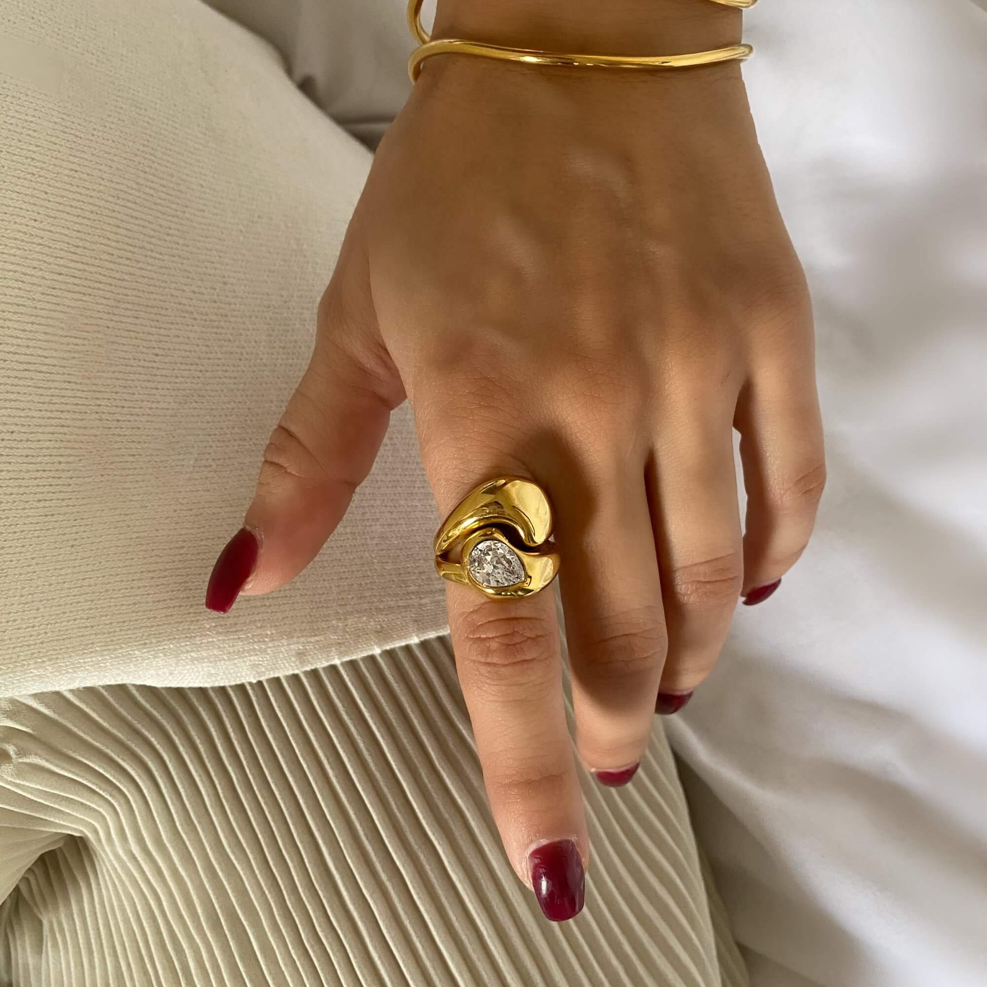 The KampyR pear diamond dome ring by Kampy Designs, styled elegantly to showcase its bold dome structure and pear-cut diamond centerpiece.