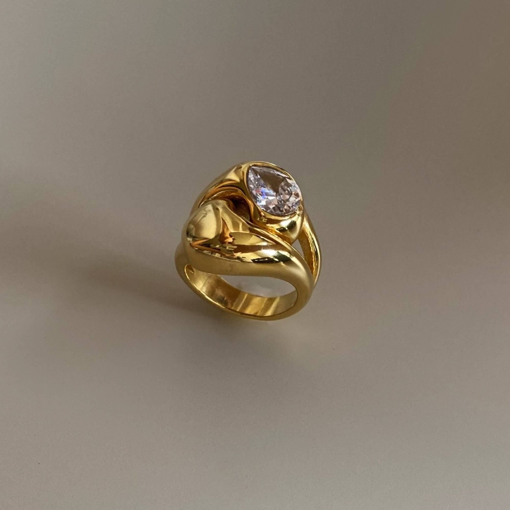 Upright view of the KampyR pear diamond dome ring by Kampy Designs, showcasing its elevated setting and elegant curvature.