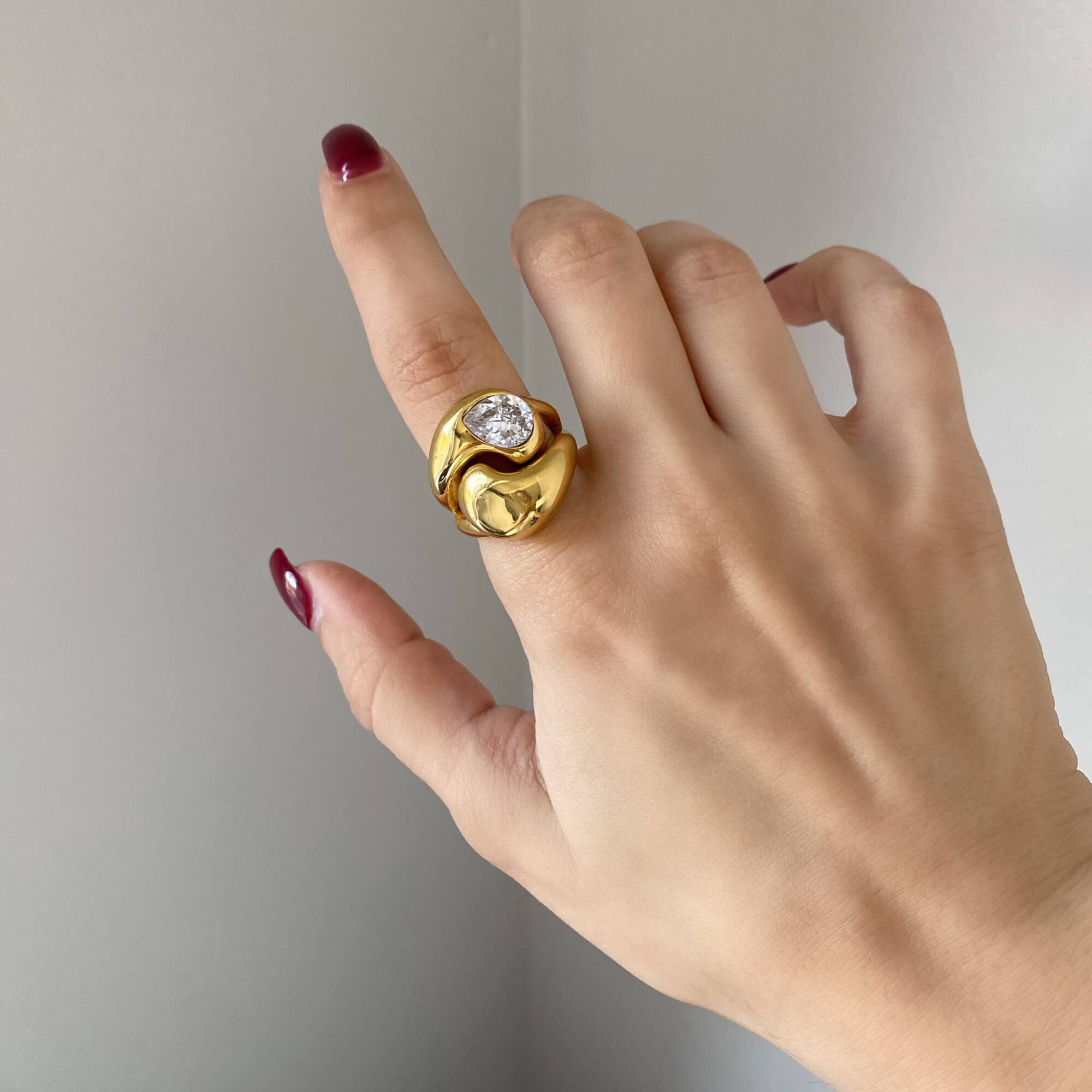 Close-up of the KampyR pear diamond dome ring by Kampy Designs, elegantly worn on a model’s hand, displaying its bold yet refined appeal.