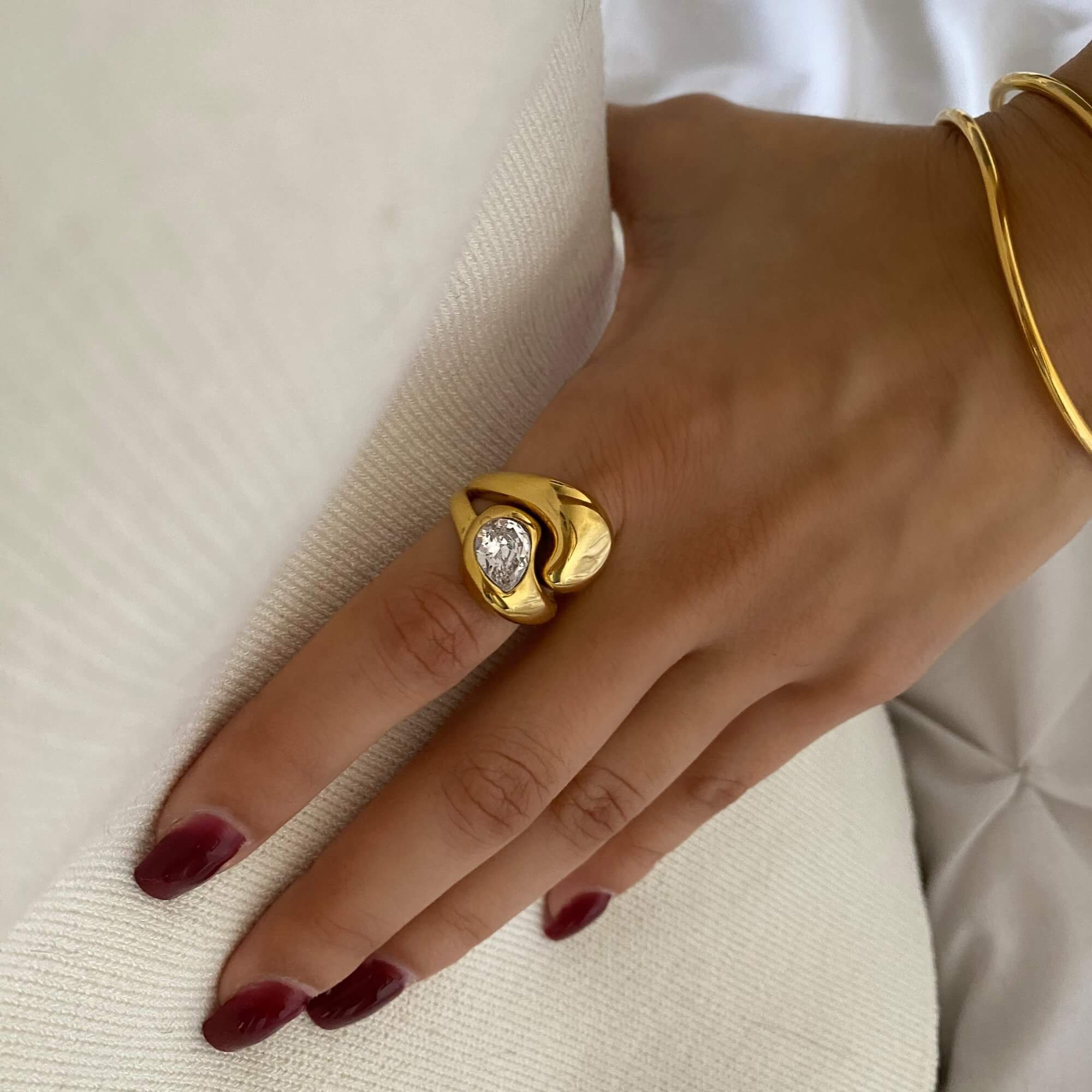 The KampyR pear diamond dome ring by Kampy Designs, worn to highlight its striking dome shape and sophisticated pear diamond centerpiece.