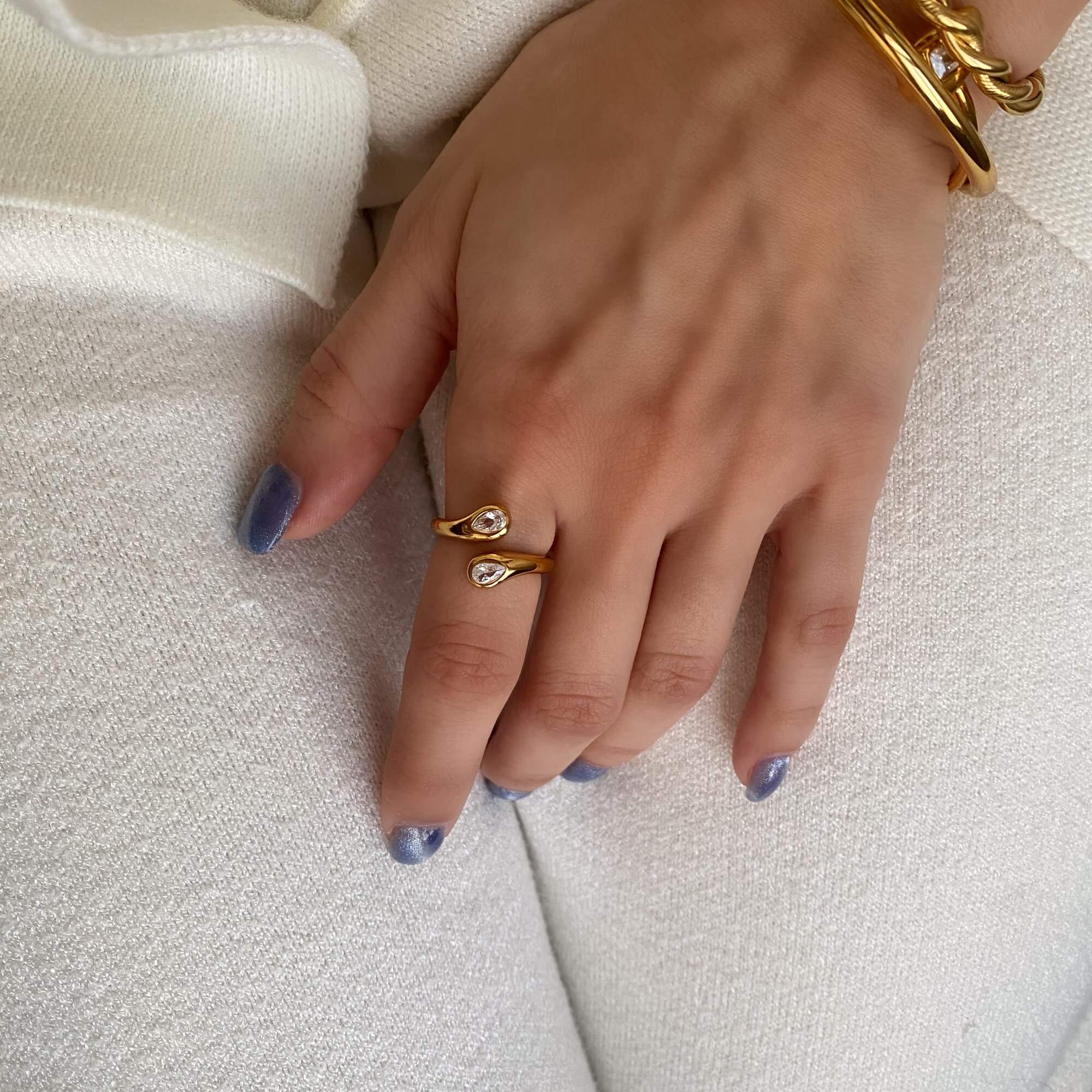 Angled view of the Kamilar pear wrap ring by Kampy Designs, highlighting the curvature and shimmering detail of the pear-cut stone.