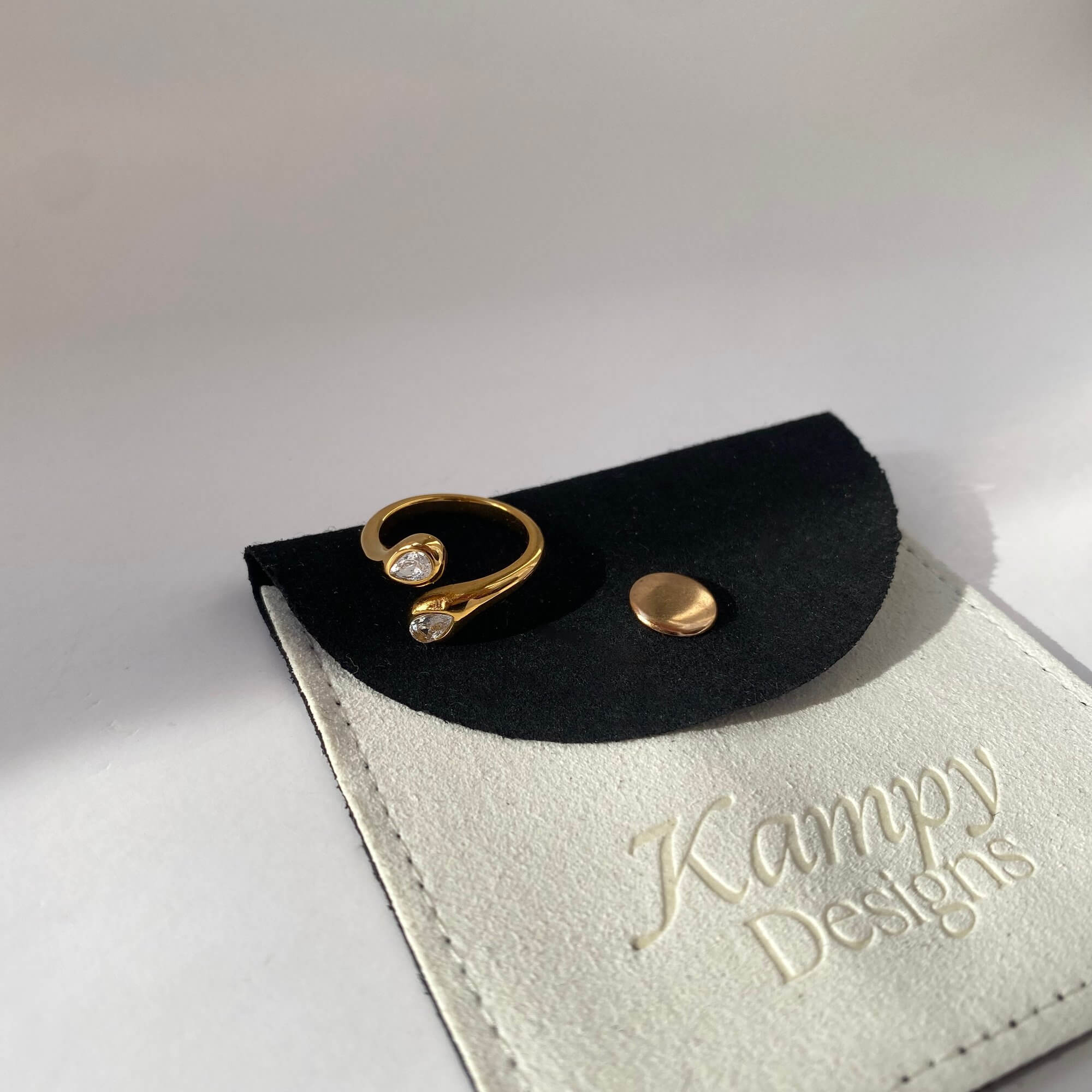 Flat lay of the Kamilar pear wrap ring by Kampy Designs on branded packaging, styled for a premium unboxing experience.