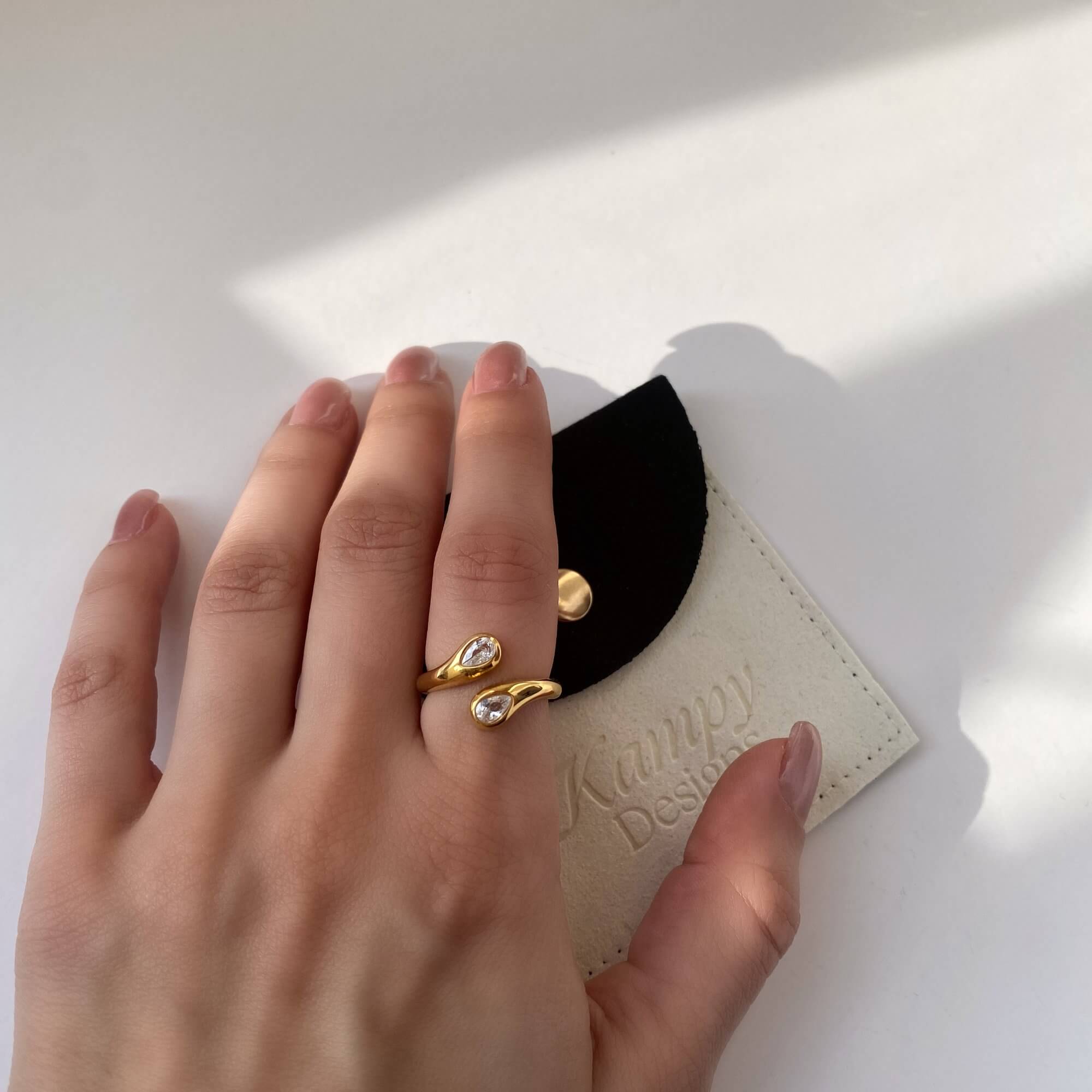On-model flat lay of the Kamilar pear wrap ring by Kampy Designs, styled with accessories for a cohesive and elegant look.