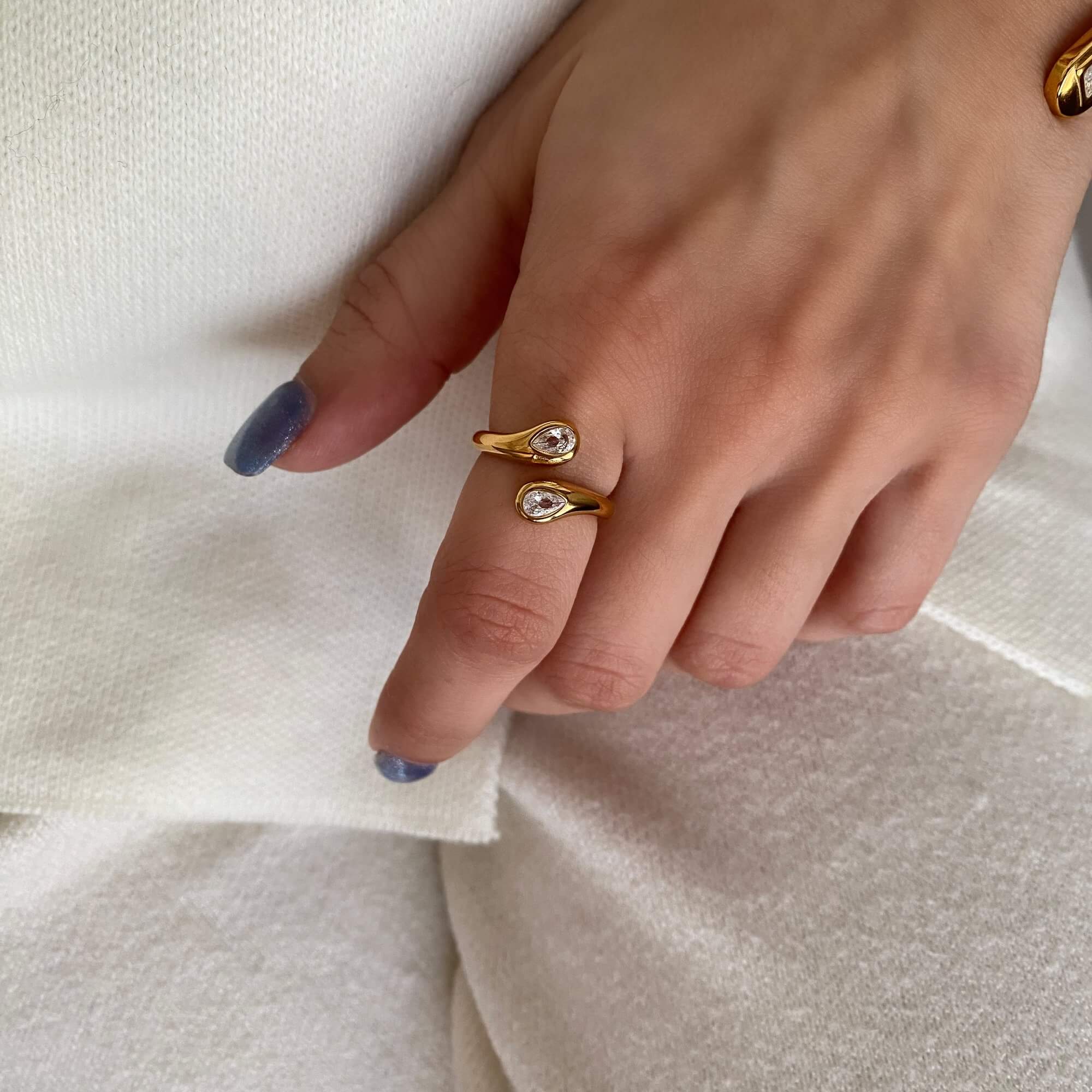 The Kamilar pear wrap ring by Kampy Designs, shown on model’s hand to highlight its flattering fit and shimmering stone.