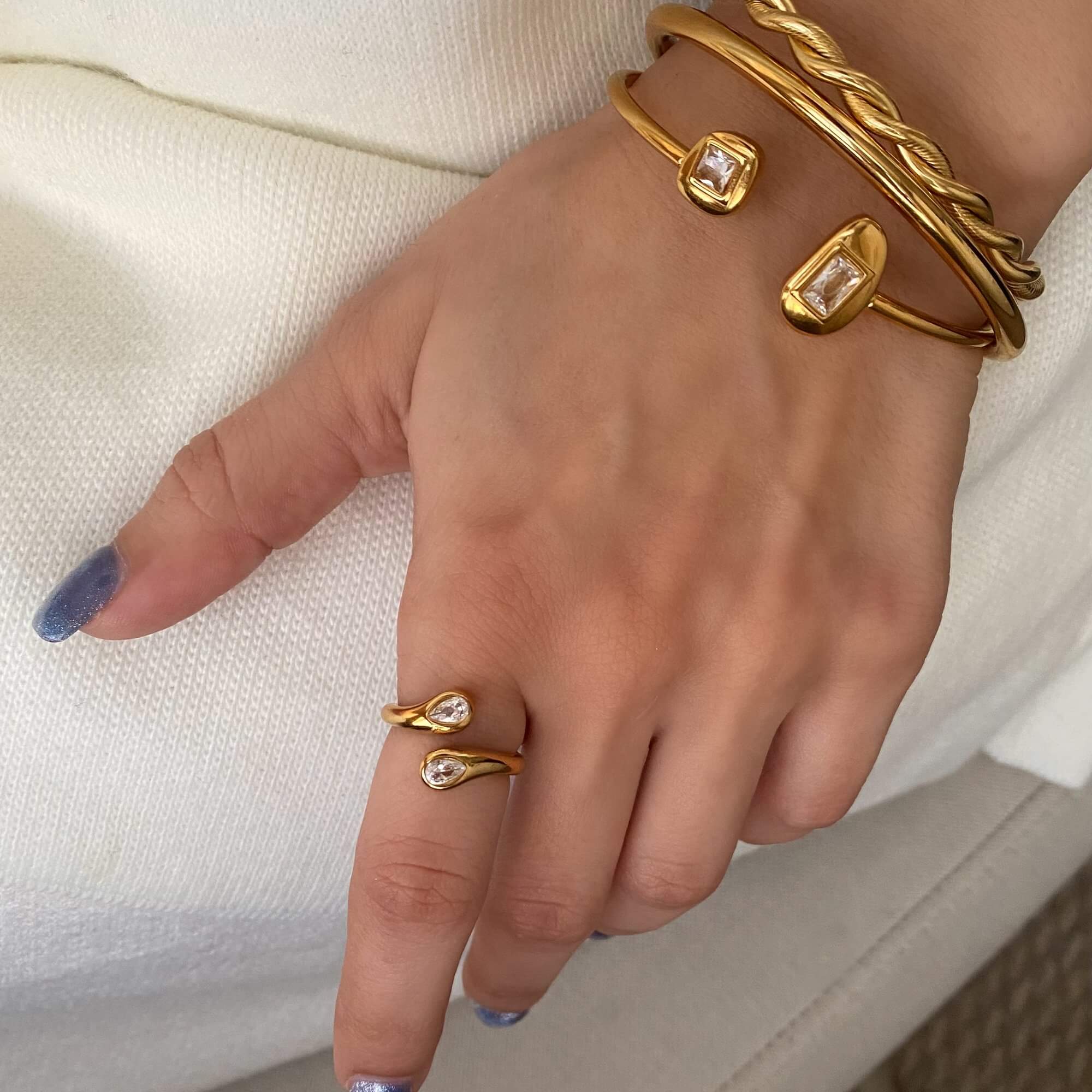 Styled view of the Kamilar pear wrap ring by Kampy Designs, featured in a modern jewelry setup highlighting elegance and versatility.