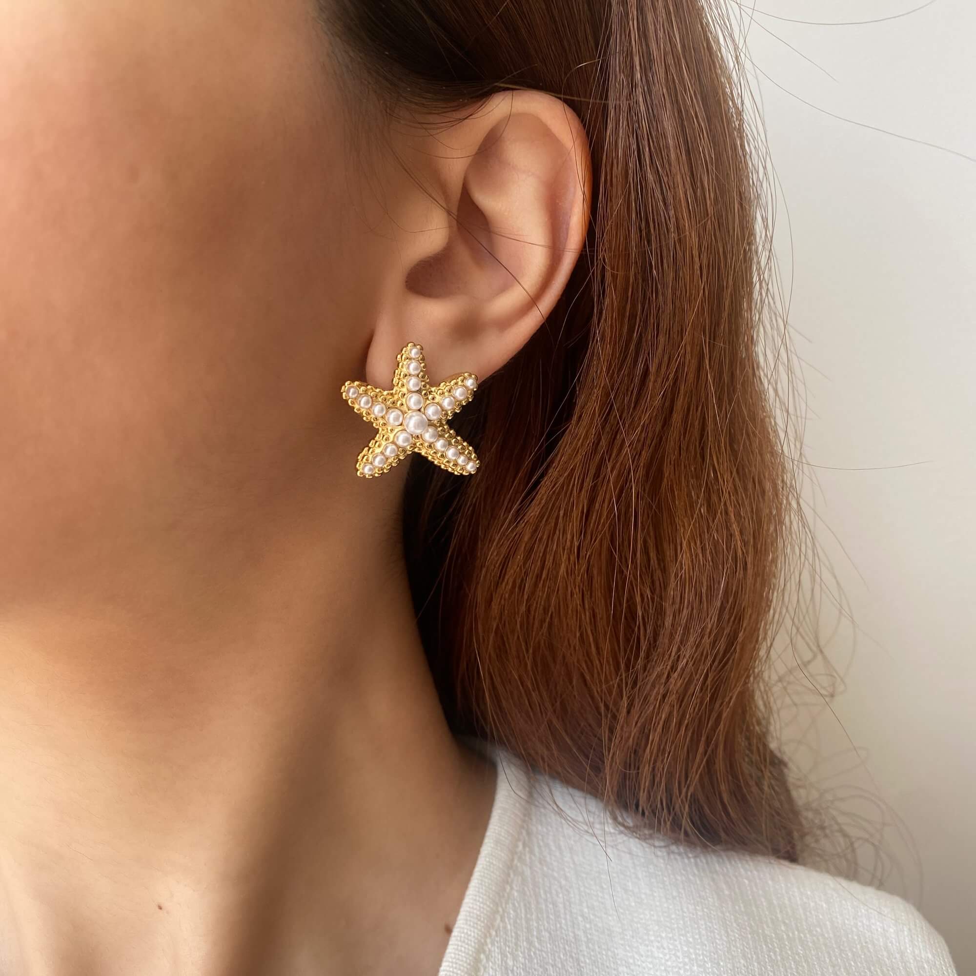 Close-up of KeachyE pearl starfish earrings by Kampy Designs, showcasing the intricate starfish design accented with luminous pearls.