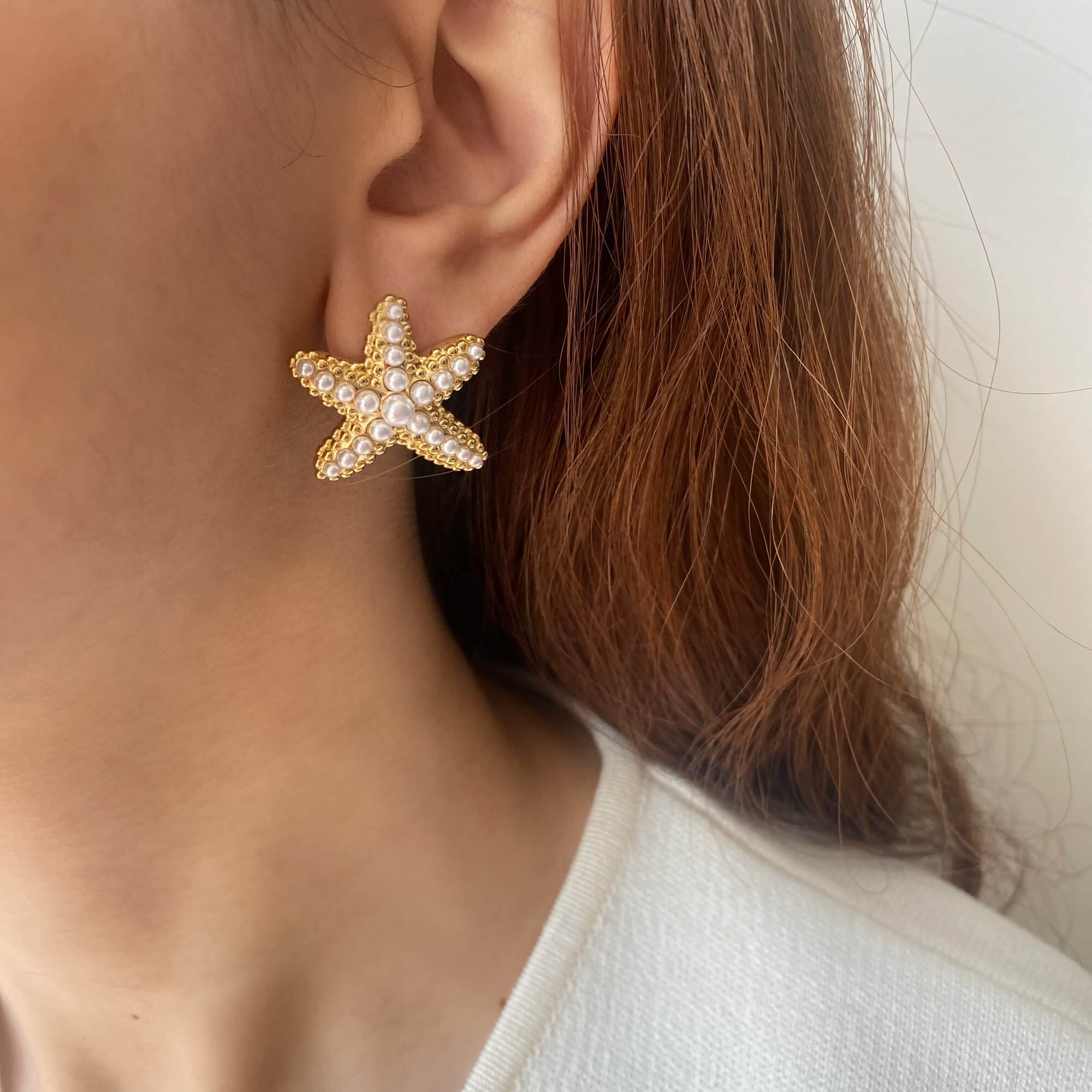 KeachyE pearl starfish earrings by Kampy Designs, styled on model’s ear for a natural coastal look and beach-ready elegance.