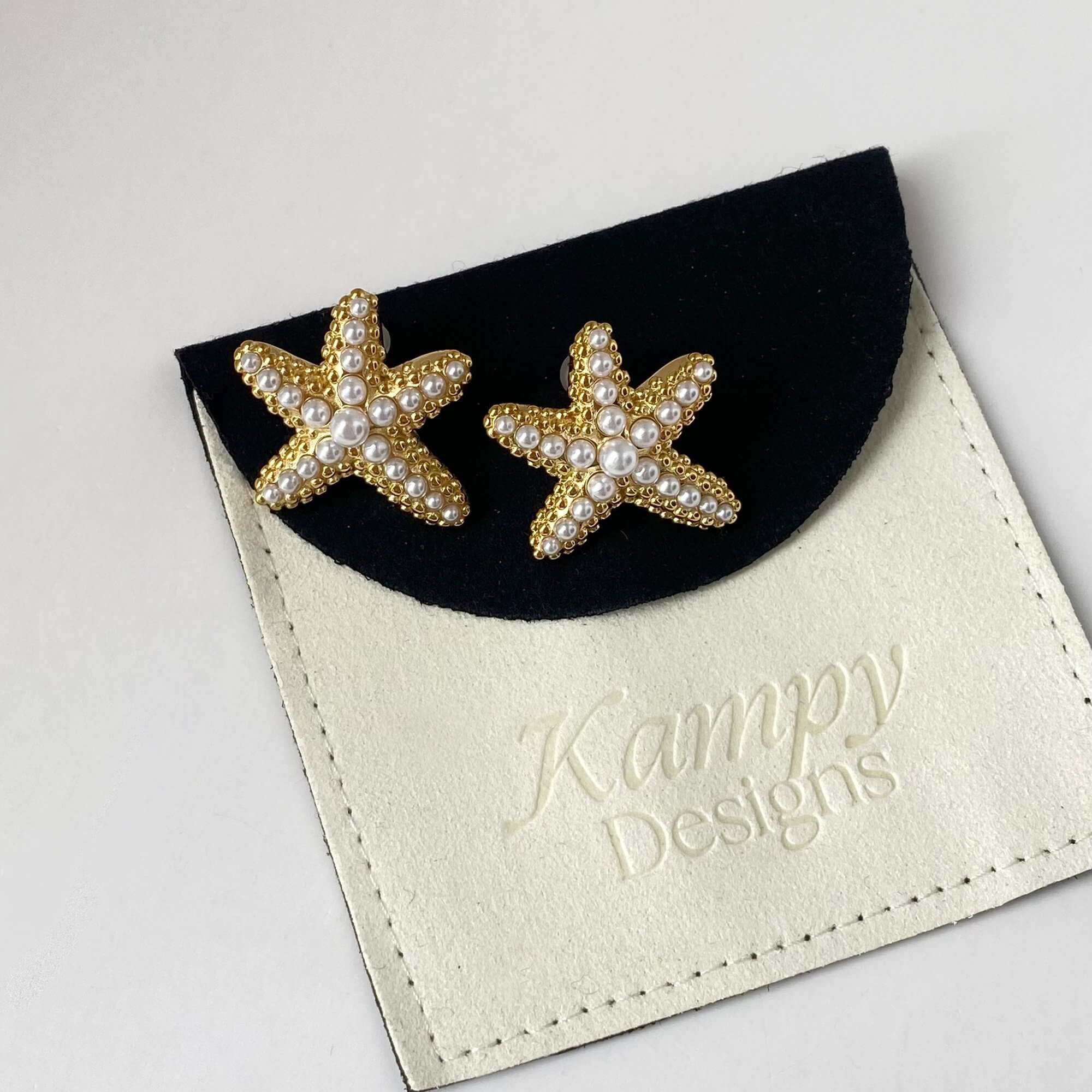 Top view of KeachyE pearl starfish earrings by Kampy Designs, displaying the symmetrical structure and embedded pearl center.