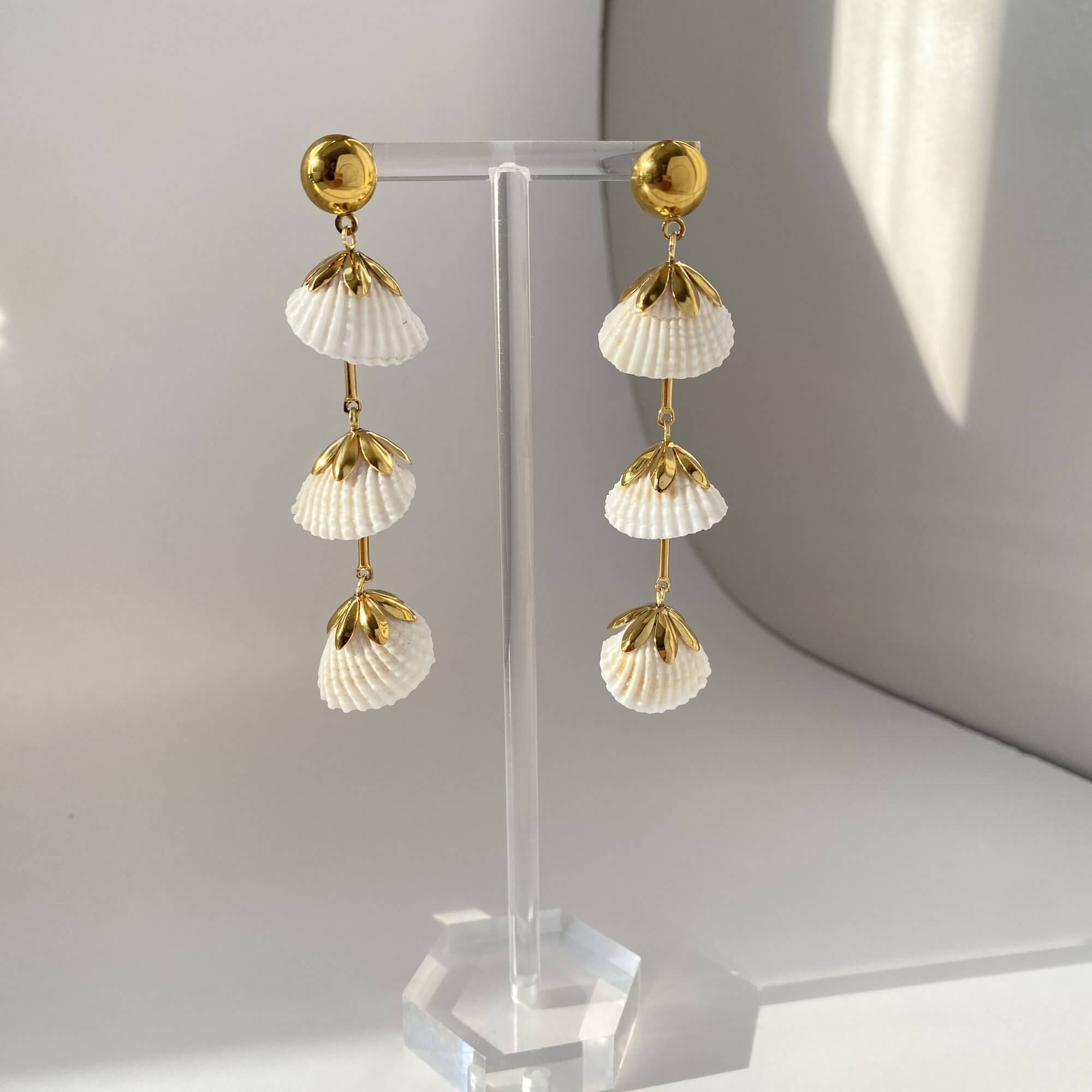 Angled view of KlamidyaE real shell dangle earrings by Kampy Designs, highlighting the natural sheen and handcrafted look of each shell.