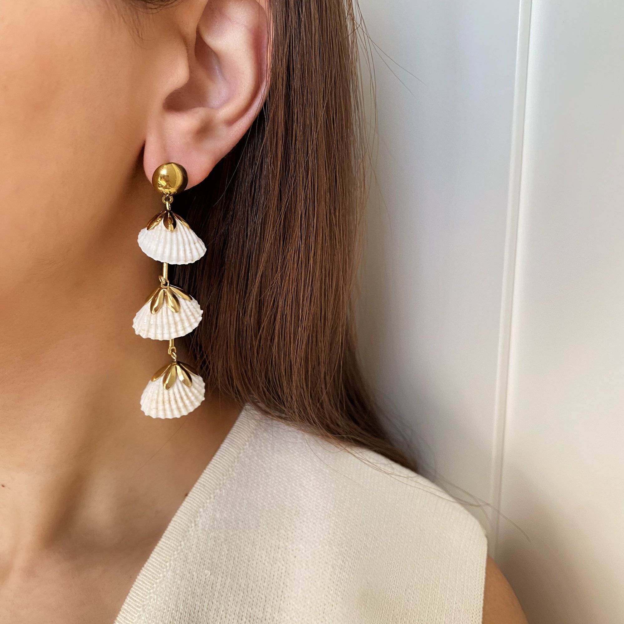 KlamidyaE real shell dangle earrings by Kampy Designs, worn on model's ear to showcase their natural seaside charm and organic texture.