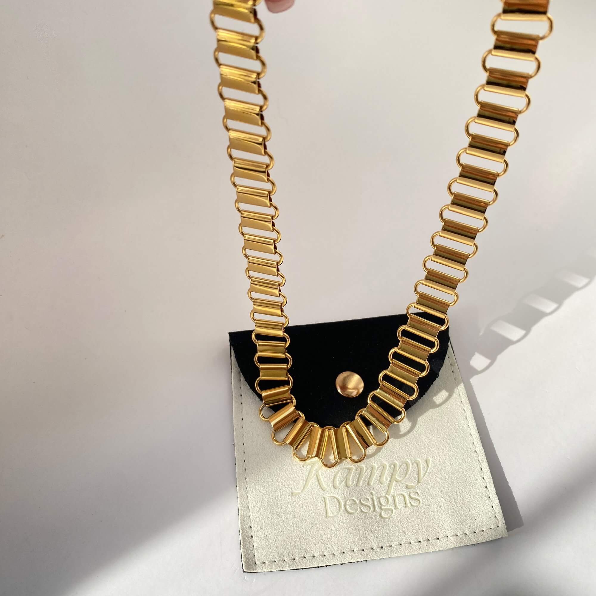 Dangle view of the KlinkyN retro gold chain necklace by Kampy Designs, showing its fluid movement and thick, interlocking chain design.