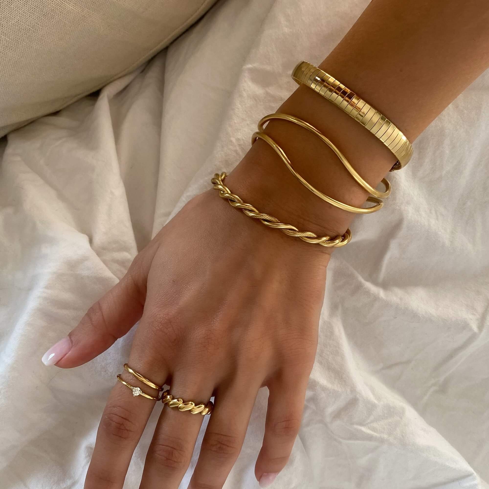 The KyraB rope twist cuff bracelet in gold and two-toned by Kampy Designs, styled to enhance any luxurious jewelry collection.