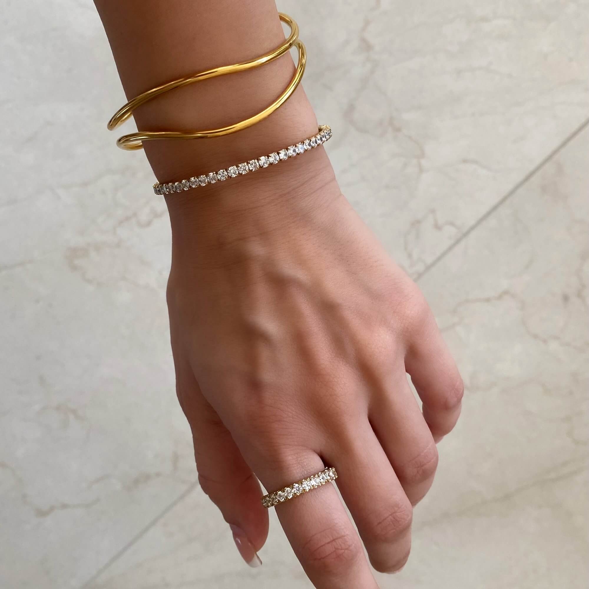 Stacked view of the KowR round diamond eternity band ring by Kampy Designs, layered with other rings to create a stylish and elegant combination.