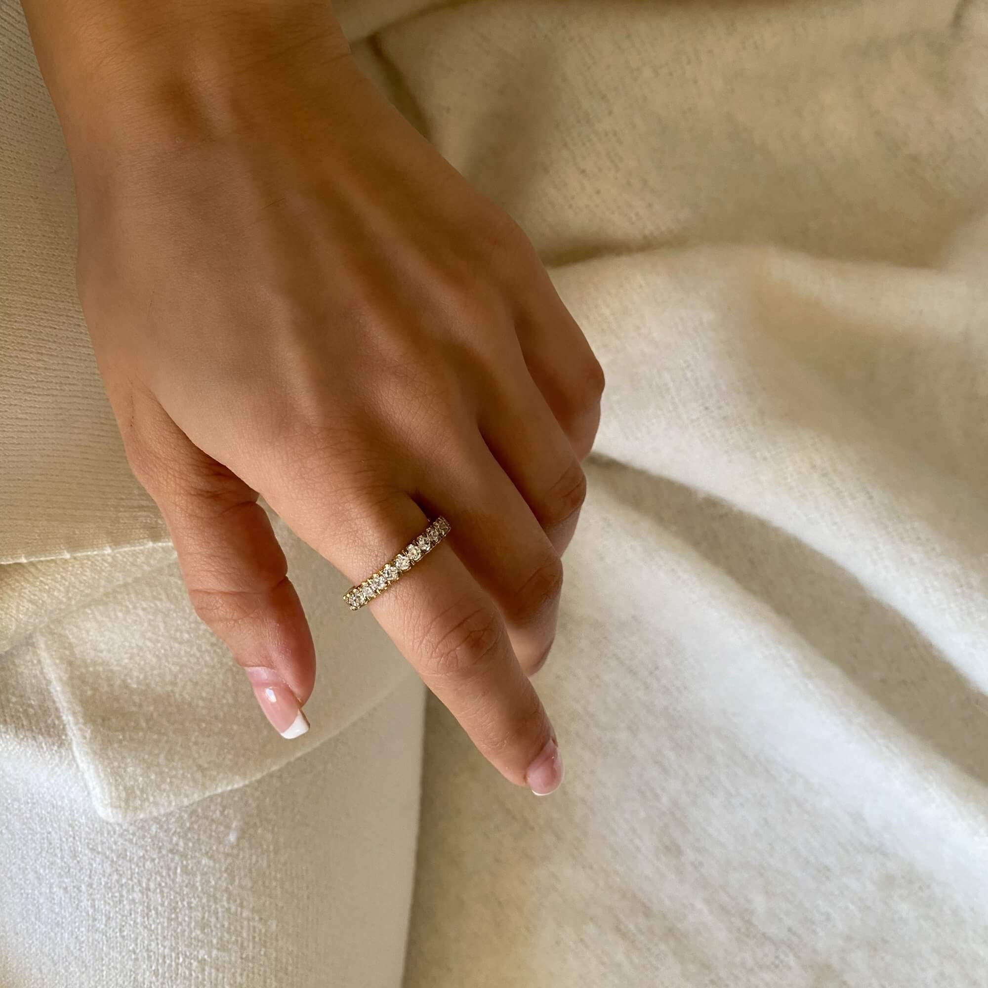 Alternative worn view of the KowR round diamond eternity band ring by Kampy Designs, elegantly displayed on a model’s hand for a refined look.
