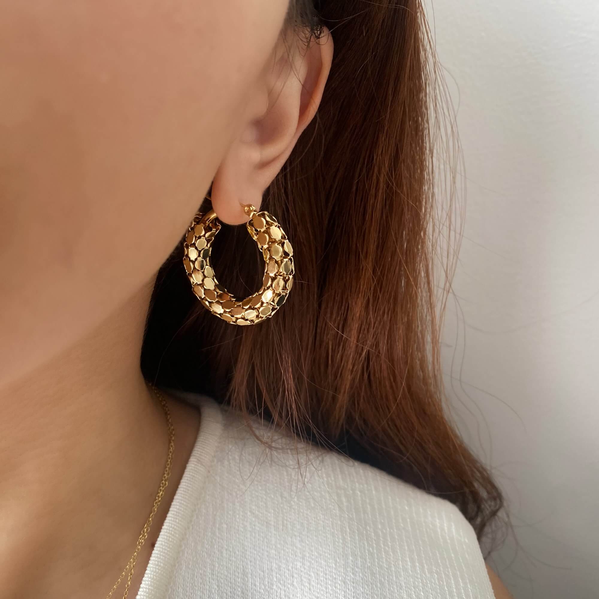 Styled view of Kassiane serpentine scale hoop earrings by Kampy Designs, worn by model for a chic editorial-inspired jewelry look.