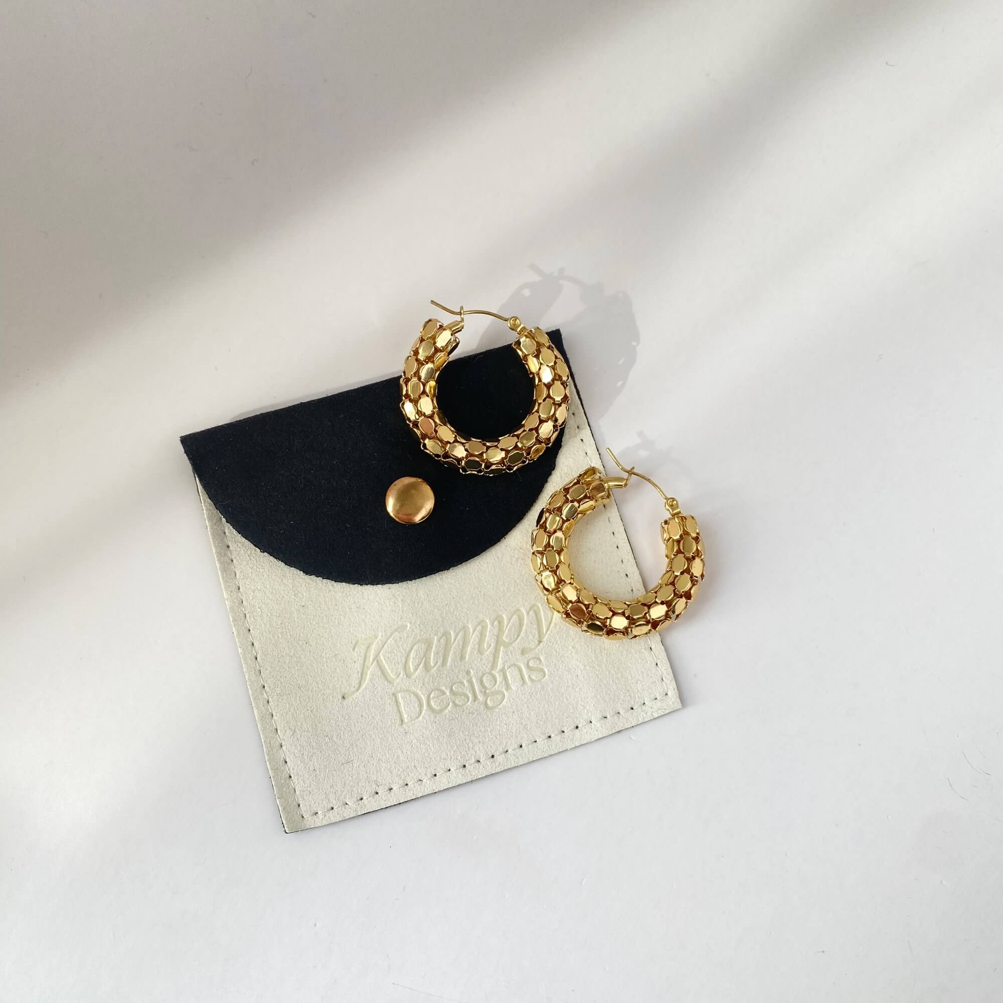 Top view of Kassiane serpentine scale hoop earrings by Kampy Designs, showing off the rounded structure and embossed serpent scale design.