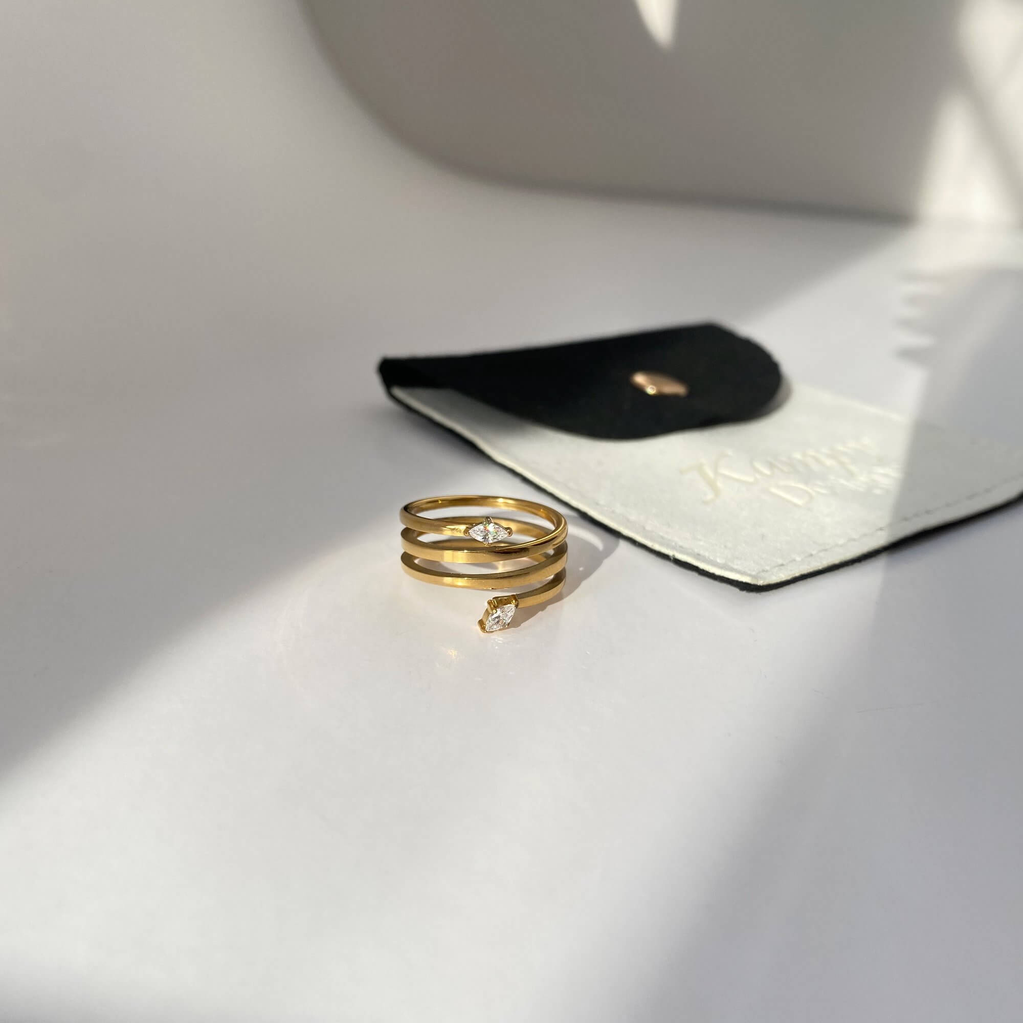 Angled view of the Kinor serpentine wrap ring by Kampy Designs, highlighting the elegant curvature and snake-inspired wrap design.