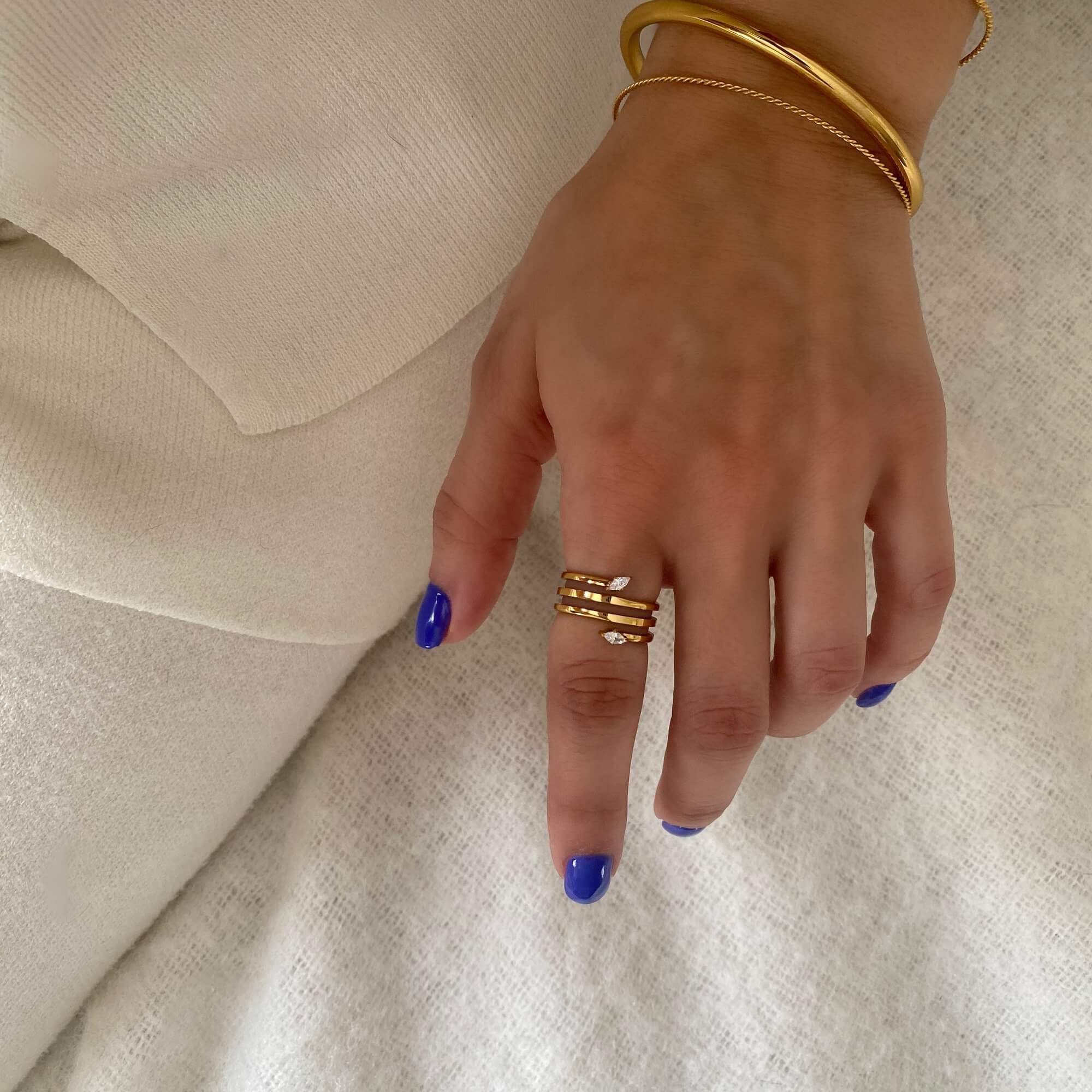 Top view of the Kinor serpentine wrap ring by Kampy Designs, shown on model’s hand to showcase the coiled top profile.