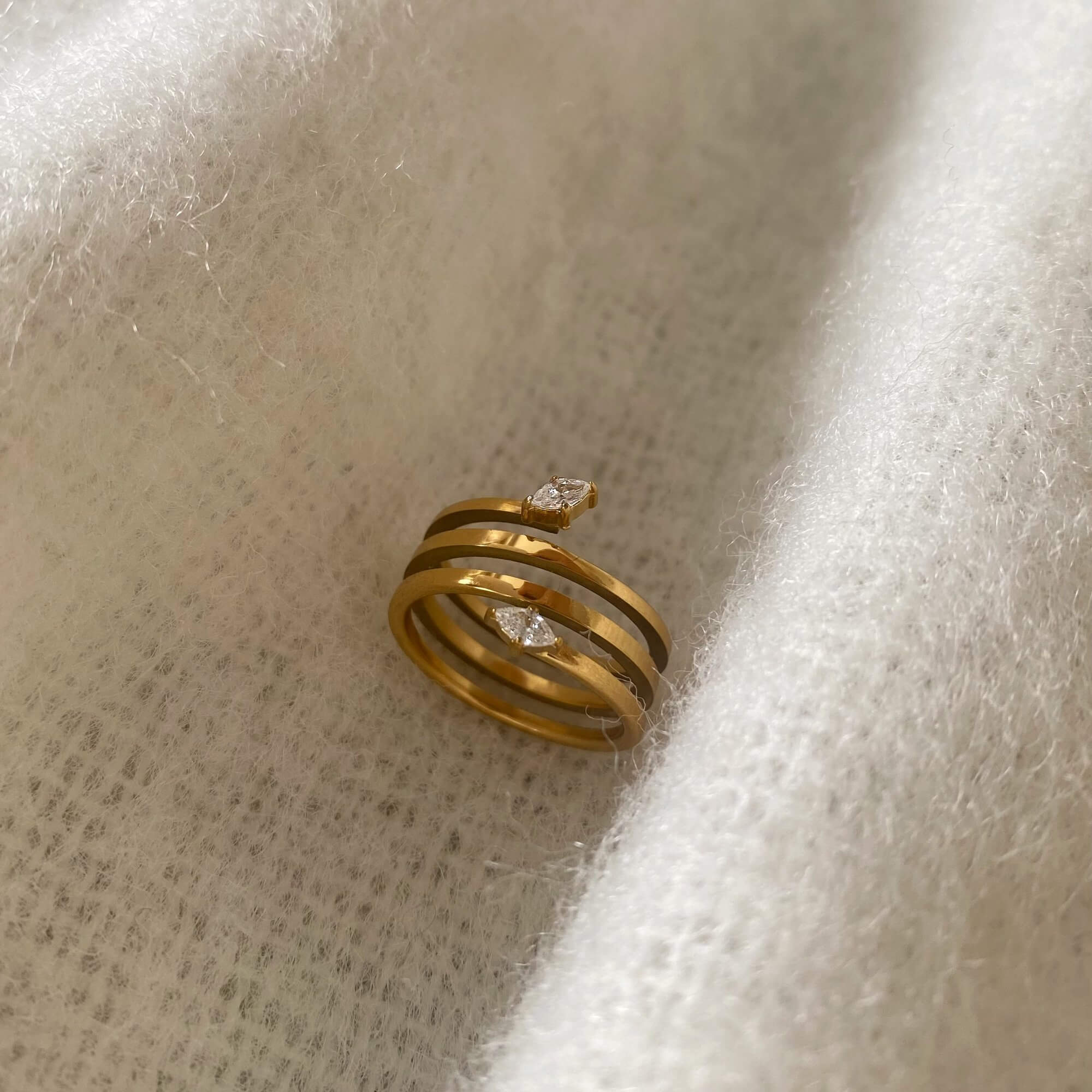 Top view of the Kinor serpentine wrap ring by Kampy Designs, showing the full spiral layout of the wrap ring from above.