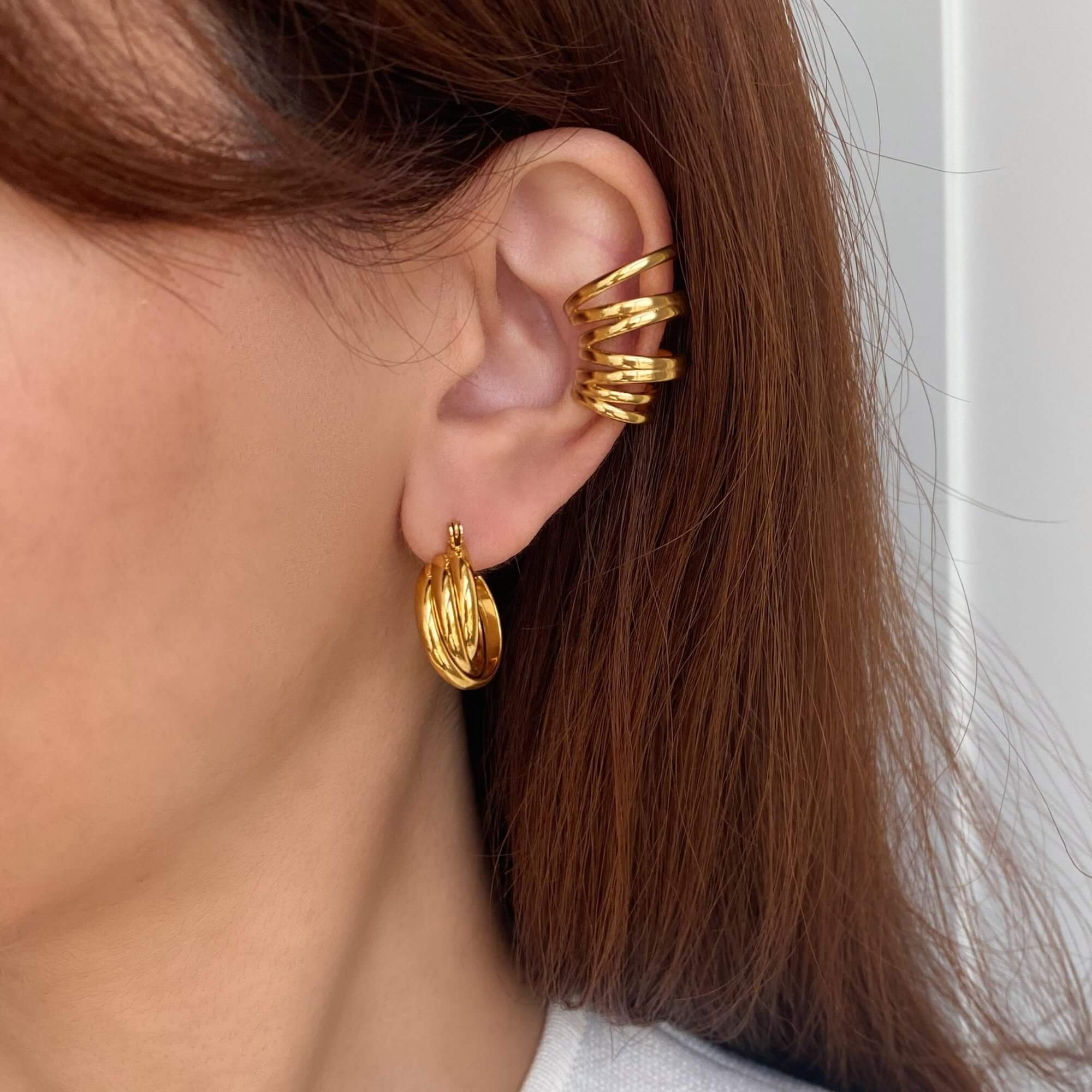 Stacked view of the KanaE stacked hoop ear cuff by Kampy Designs, styled with multiple ear cuffs for a trendy, layered effect.