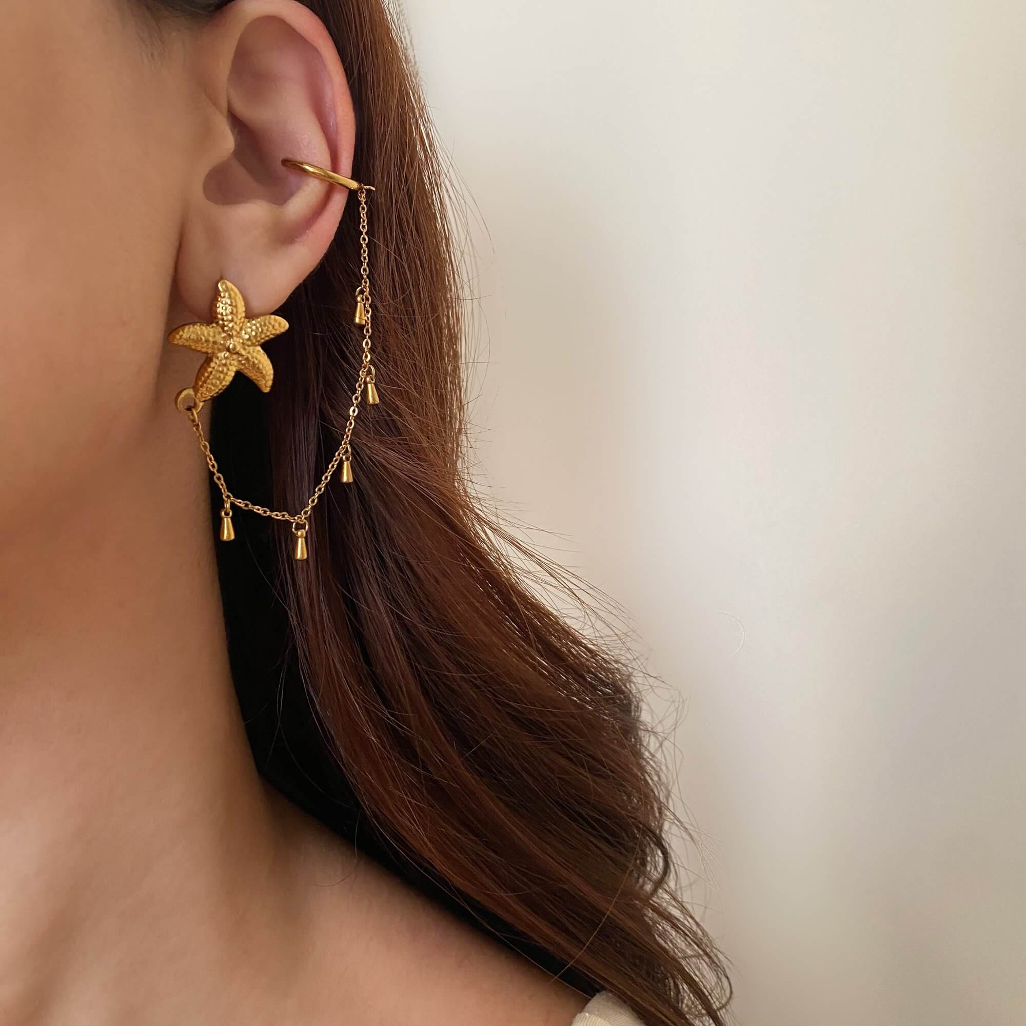 Angled view of the KarlyE starfish chain cuff earrings by Kampy Designs, highlighting their unique starfish shape and delicate draping chain.