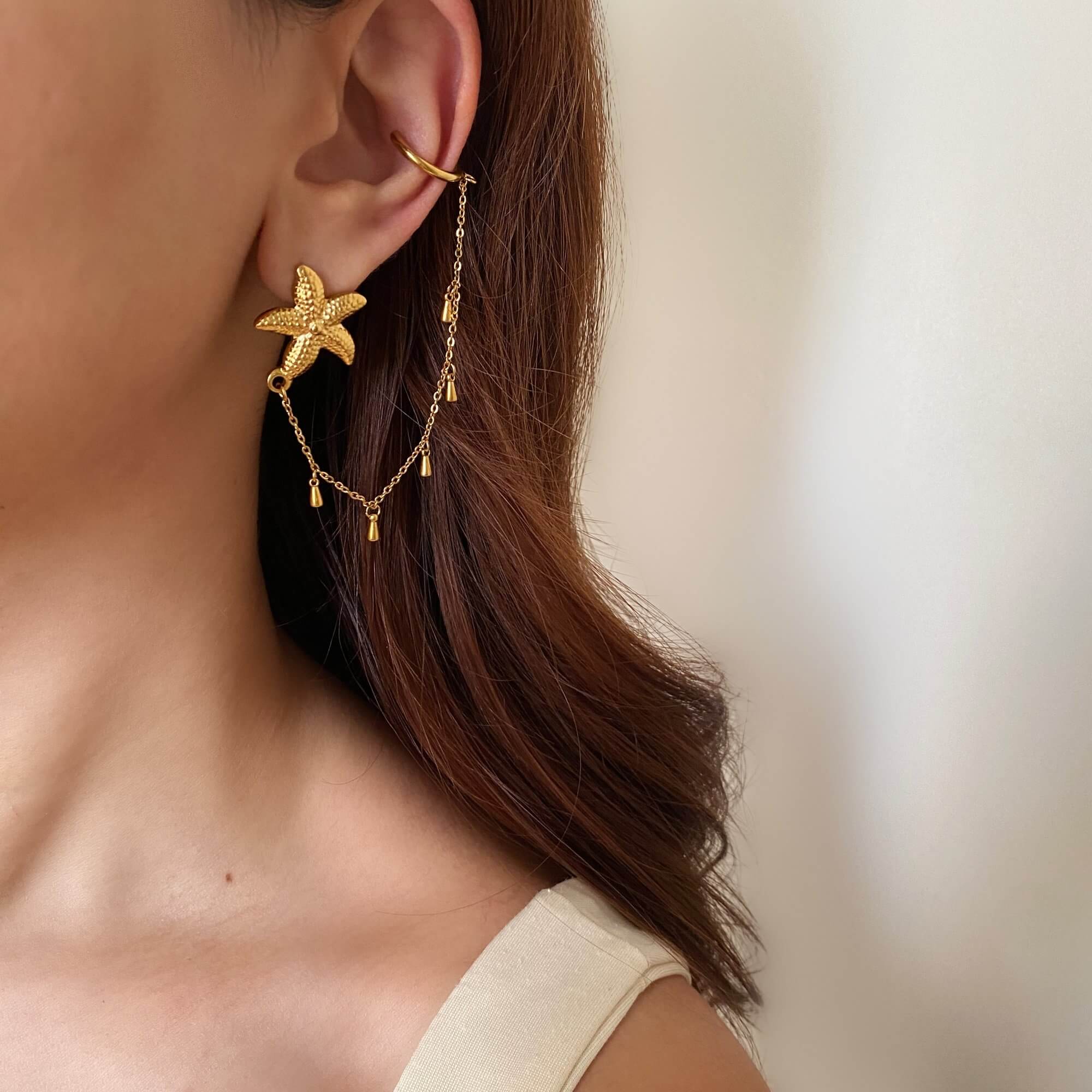 The KarlyE starfish chain cuff earrings by Kampy Designs, elegantly worn to showcase their ocean-inspired charm and stylish chain-link design.