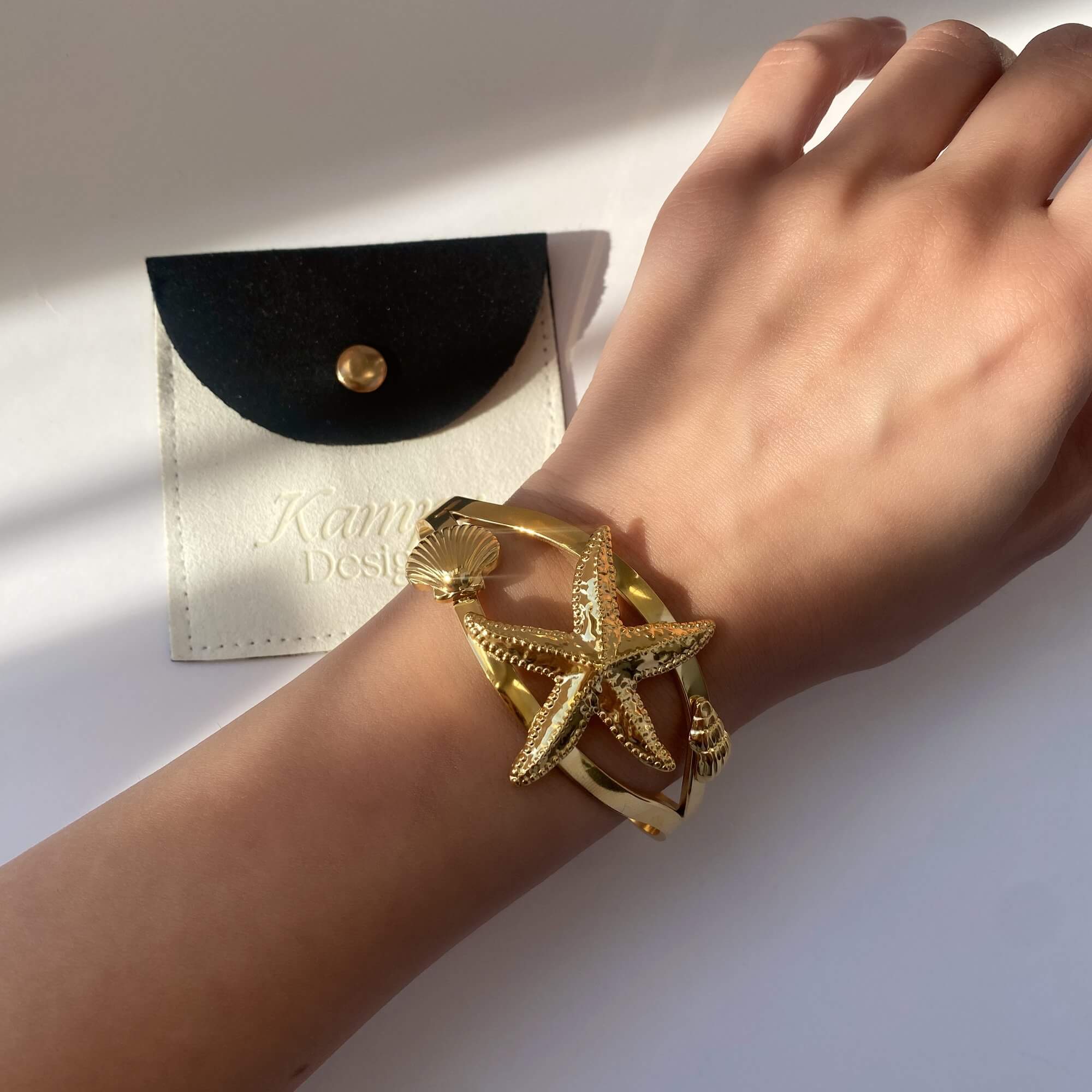 Close-up of the KoralB starfish cuff bracelet by Kampy Designs, worn on the wrist to showcase its coastal-inspired charm and textured finish.