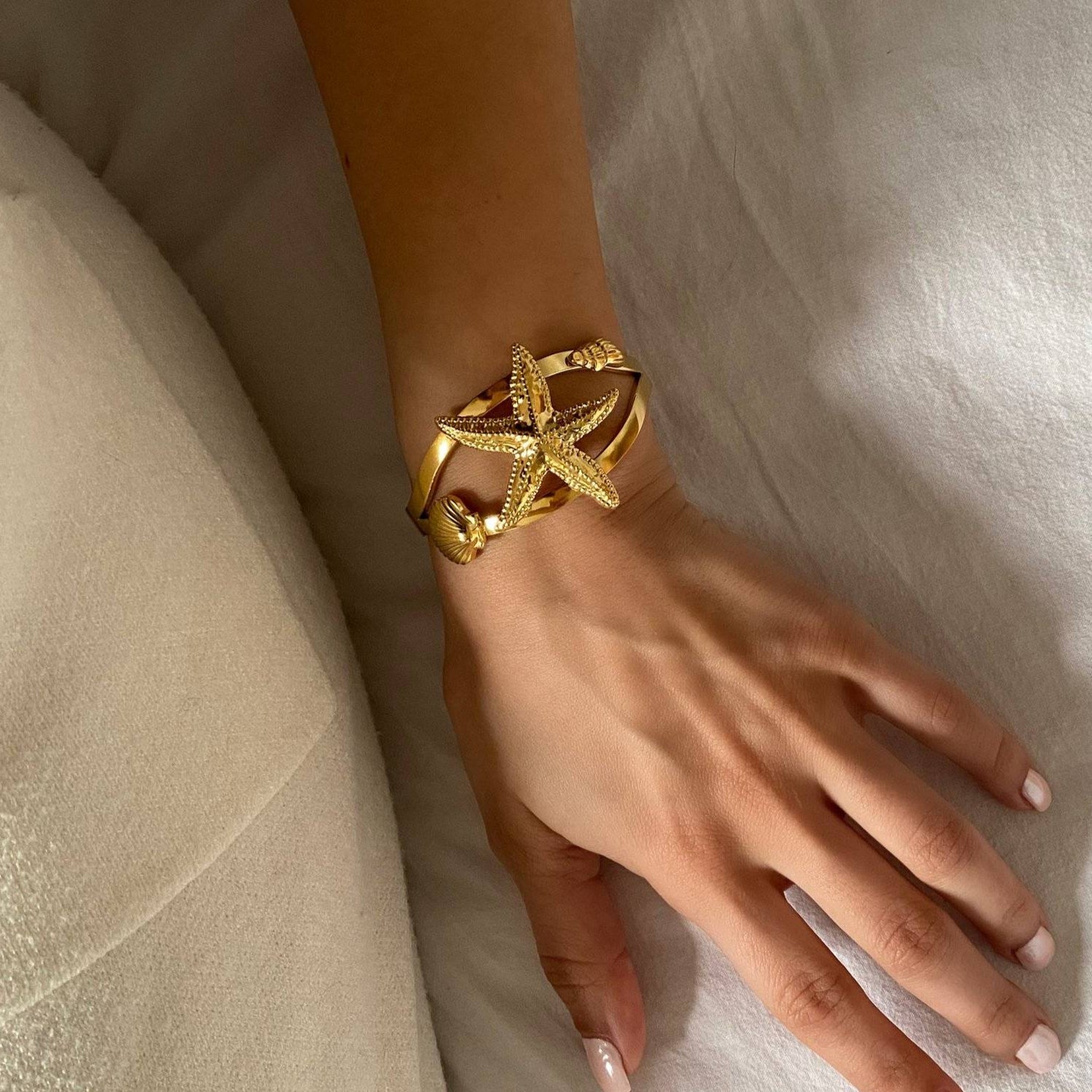 Side view of KoralB starfish cuff bracelet by Kampy Designs, styled on wrist to show its dimensional form and statement silhouette.