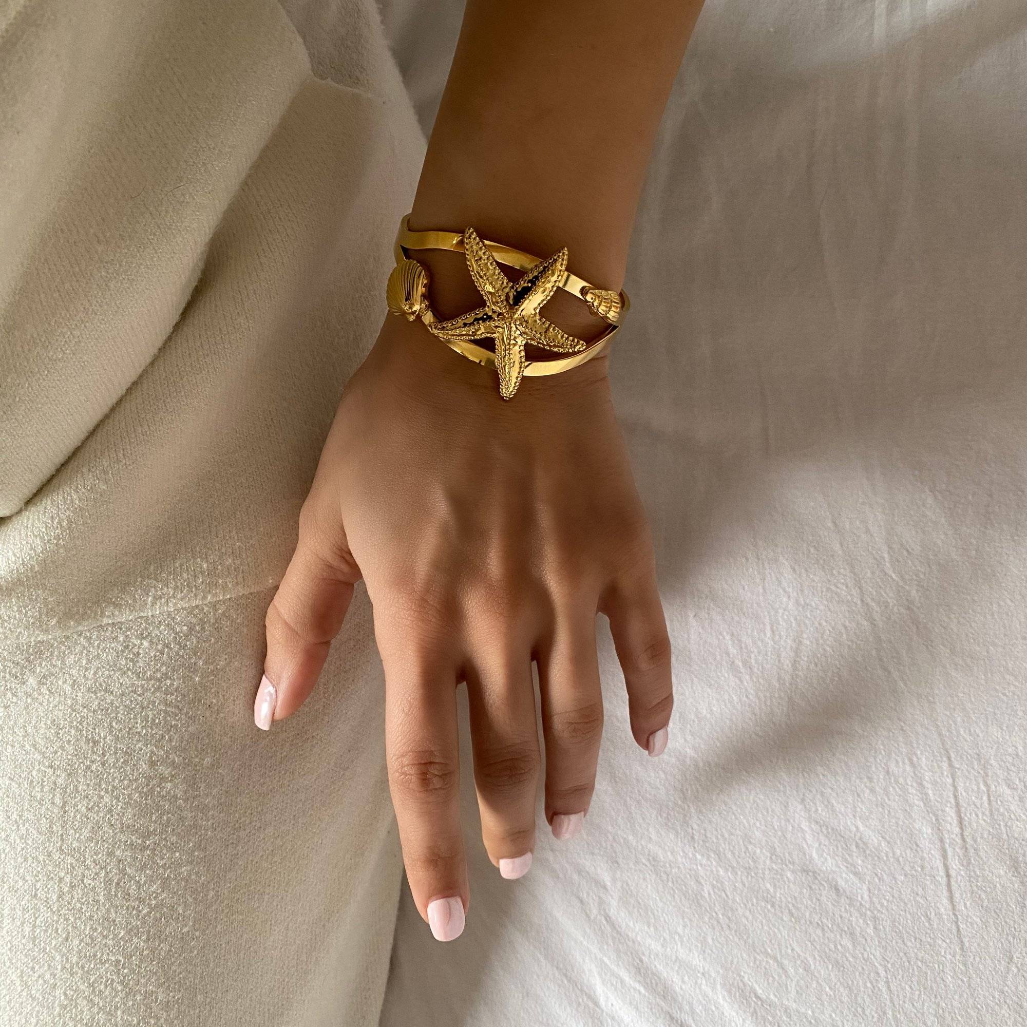 Top view of the KoralB starfish cuff bracelet by Kampy Designs, worn on model to emphasize its bold centerpiece and open cuff structure.