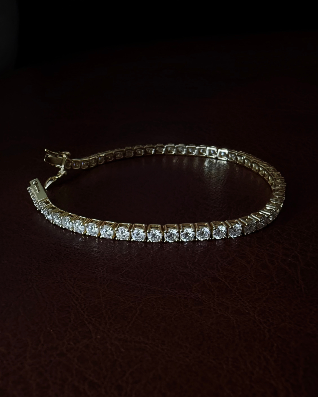 Flat lay of sterling silver lab-grown moissanite tennis bracelet with approximately 5ct total weight — Kampy