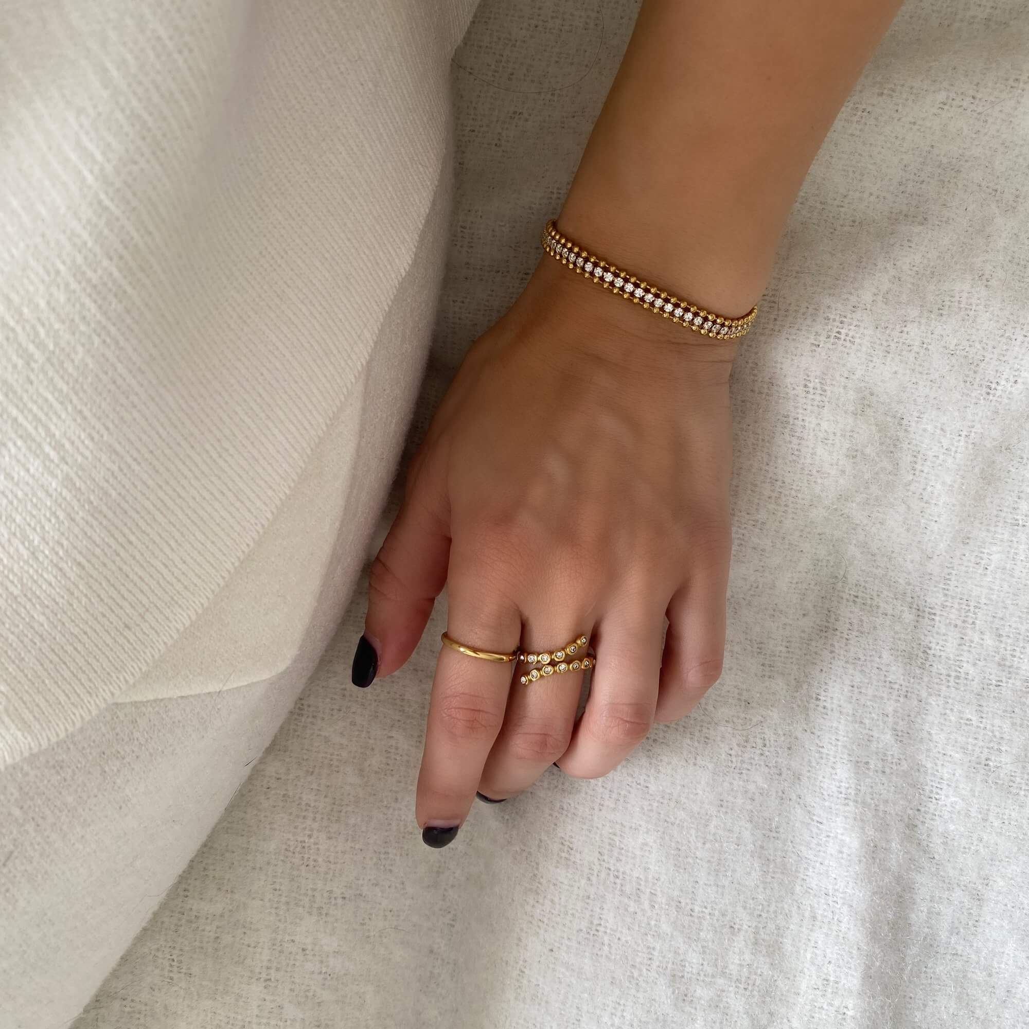 Styled shot of the KaperB tennis chain bracelet by Kampy Designs, paired with other jewelry for a polished and fashion-forward look.