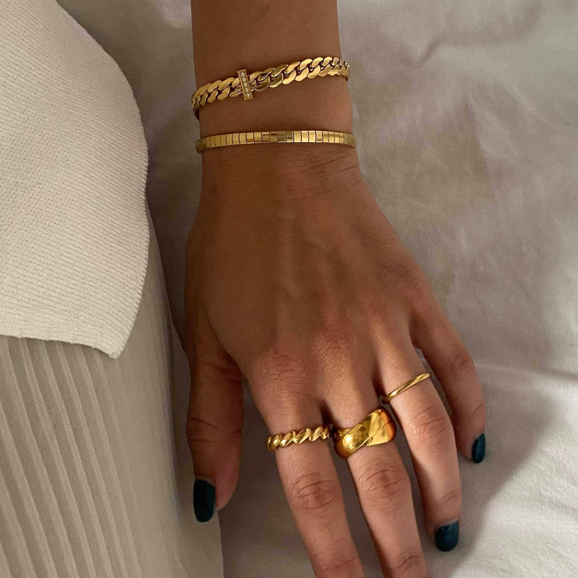 Stacked view of the KatR thick interlocking ring by Kampy Designs, layered with other rings for a stylish, statement look.