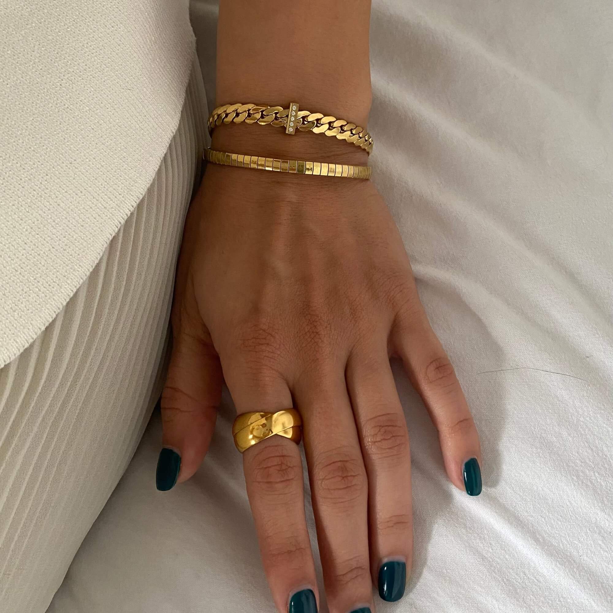 The KatR thick interlocking ring by Kampy Designs, styled to highlight its luxurious and contemporary design.