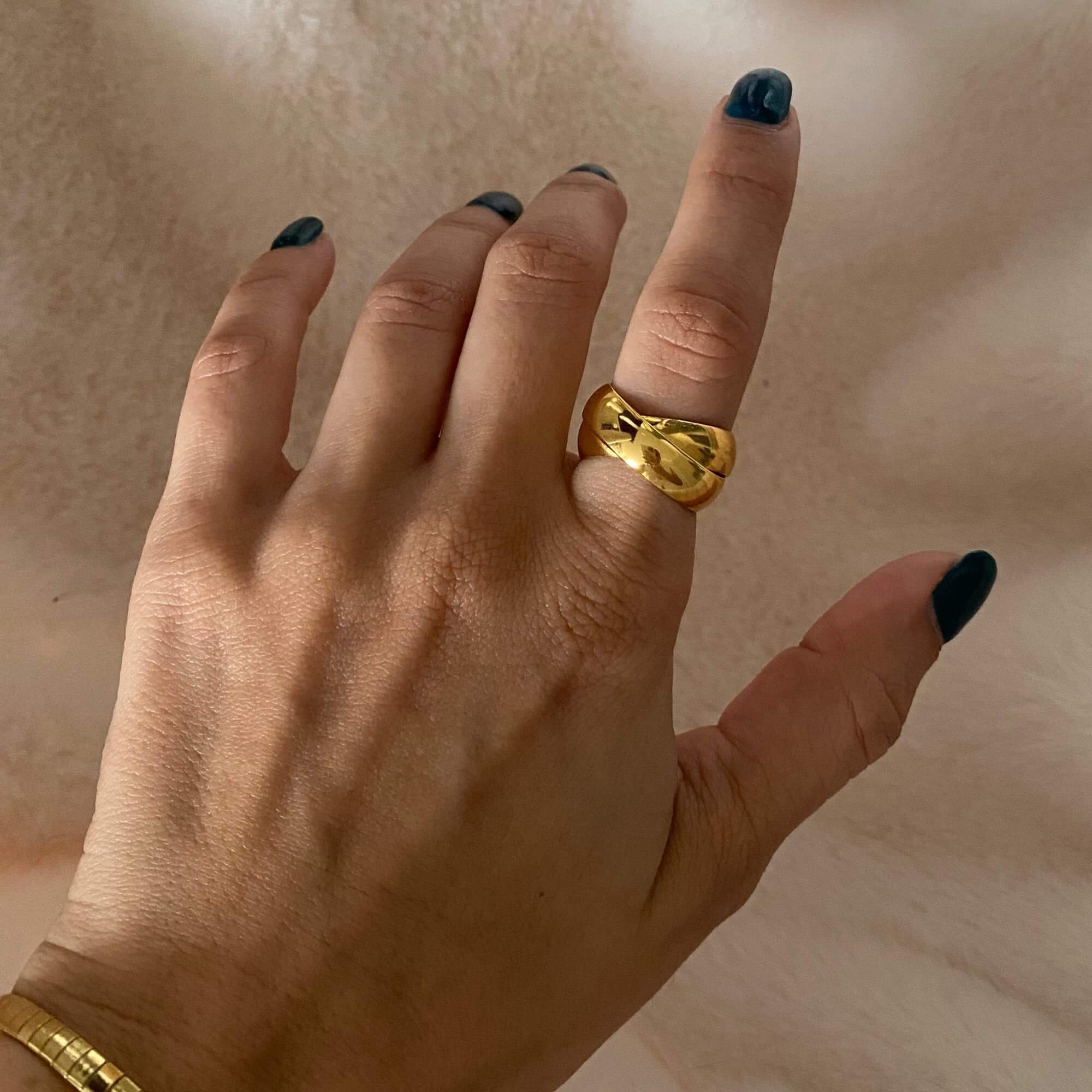 Top-down view of the KatR thick interlocking ring by Kampy Designs, showcasing its bold, intertwined band design and polished gold finish.