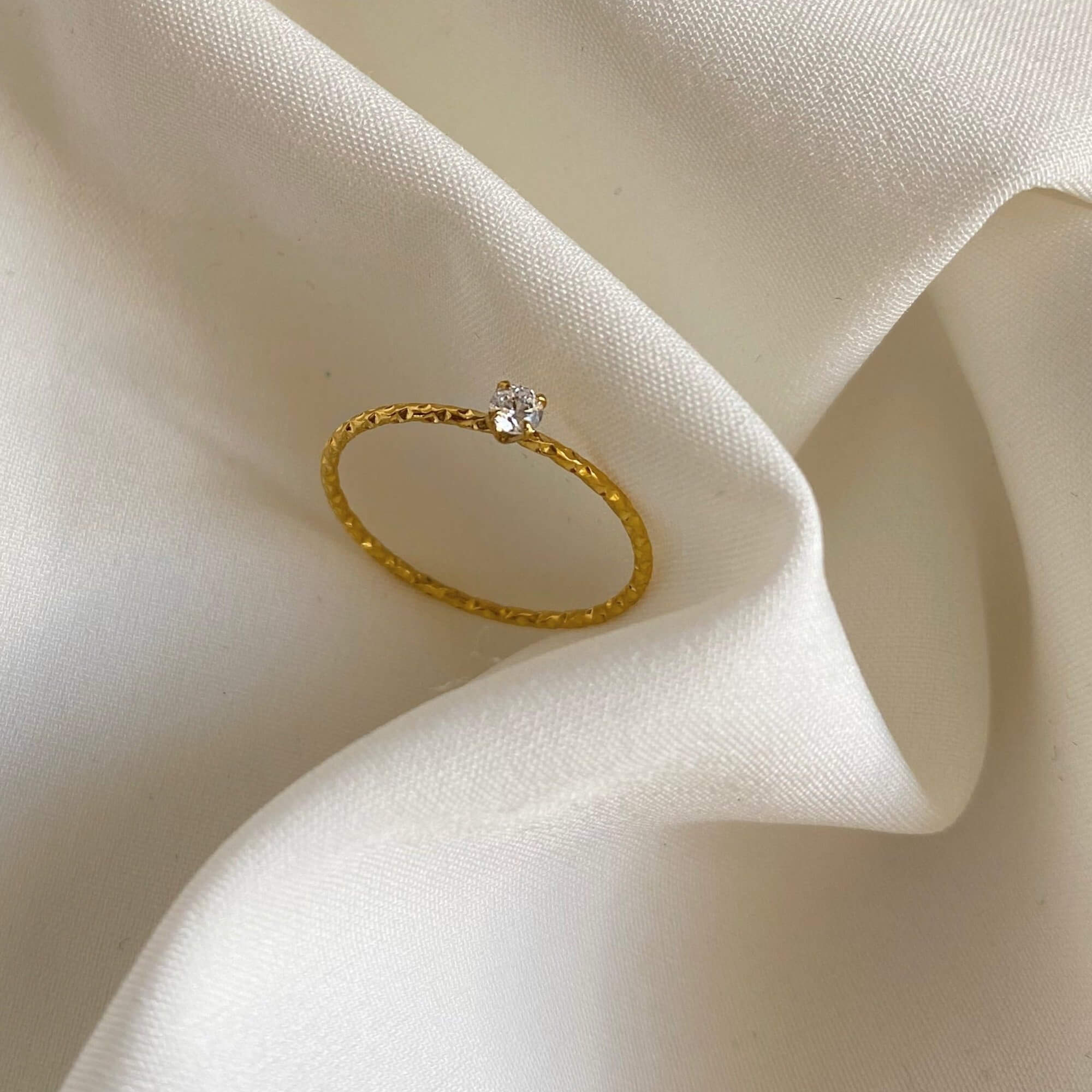 Front view of the KikoR thin diamond stacker ring by Kampy Designs, highlighting its sleek gold band and radiant diamonds.