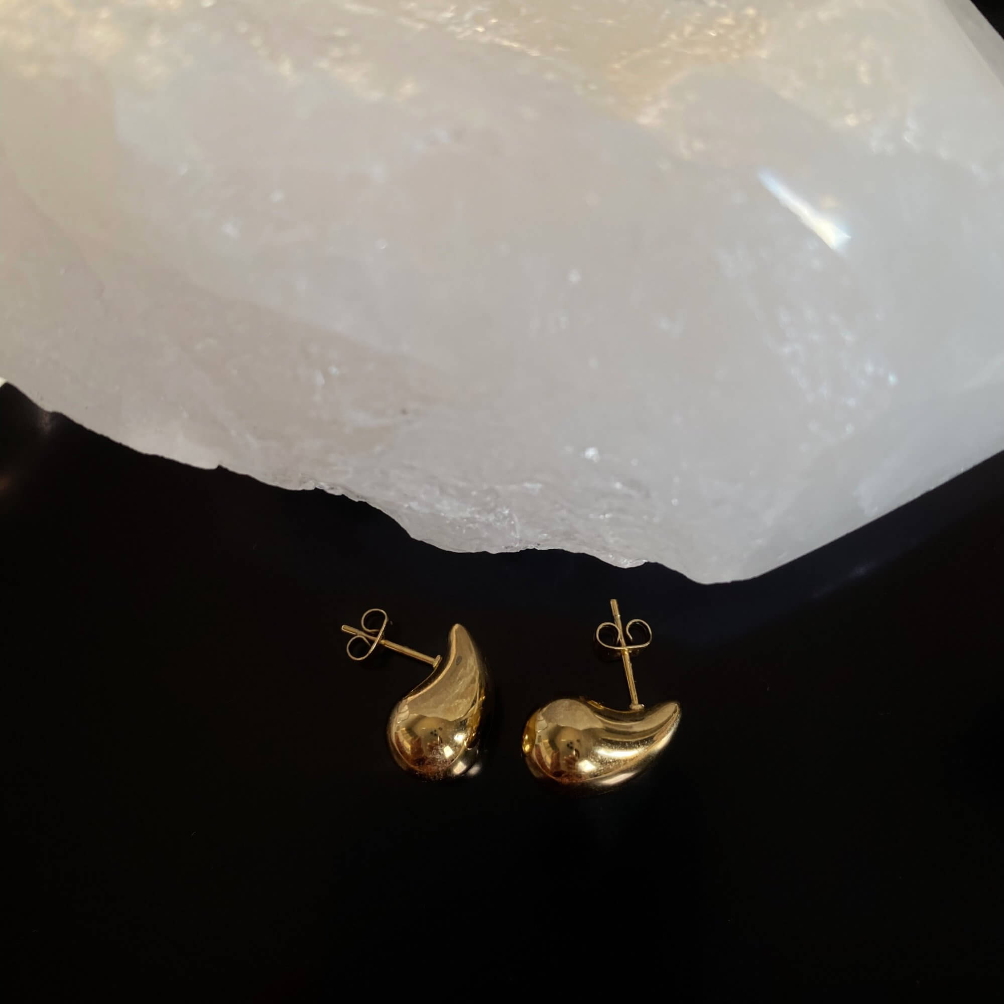 Side view of the KapreseE tiny gold tear drop earrings by Kampy Designs, emphasizing their lightweight and graceful design.
