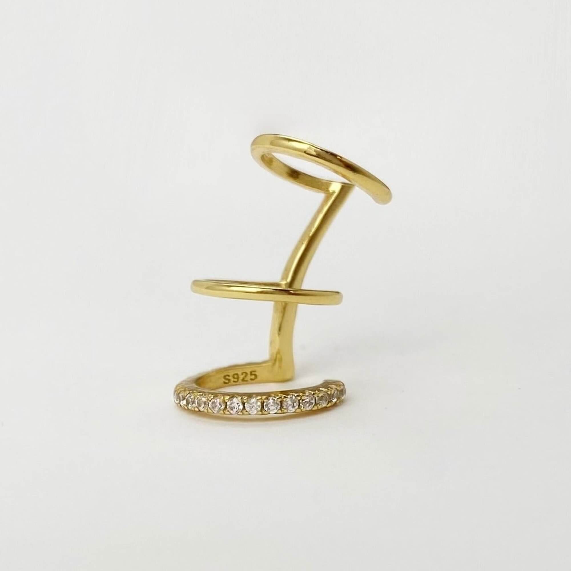 Flat view of the KarlaE triple hoop CZ ear cuffs by Kampy Designs, showcasing their bold yet elegant triple-layered design.